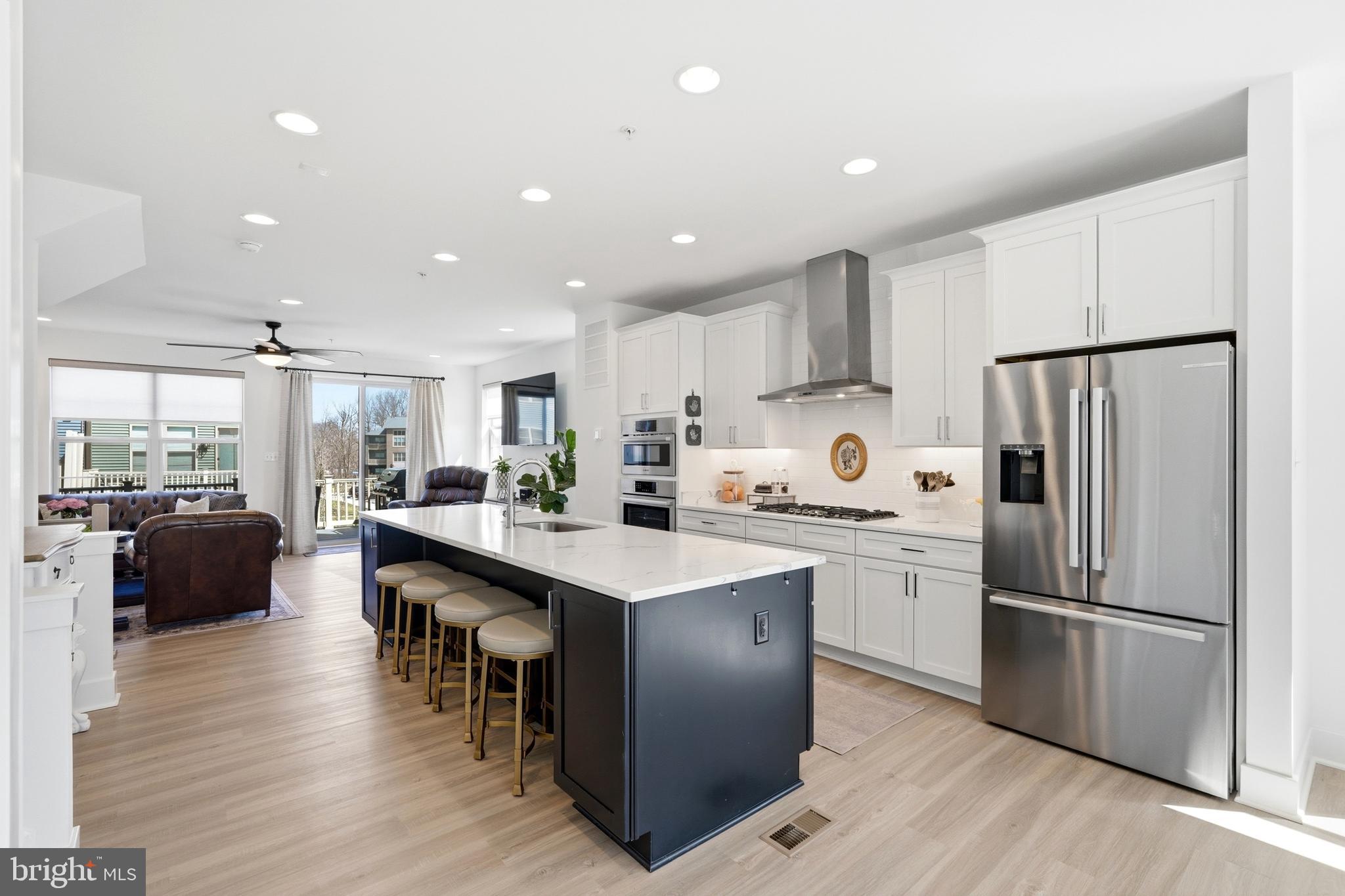 BETTER THAN NEW CONSTRUCTION! OPEN HOUSE Saturday 5/30, 12-2 PM!!!! Skip the wait. Start living here NOW! If you’ve been considering new construction, this is your opportunity to step into a home that already has it all. Built in 2023 by Craftmark Homes, this gorgeous end unit townhome offers 3 bedrooms, 2 full and 2 half baths, over 2,000 sq ft, and a two car garage, combining style, space, and ultimate convenience! What truly sets this home apart is the natural light on all THREE sides, thoughtful upgrades throughout, and a layout that just works! The main level is designed to impress with an open concept living space anchored by a sleek chef’s kitchen (the heart of the home!) featuring premium Bosch appliances, an oversized island, quartz countertops, white cabinetry, a subway tile backsplash, and a generous pantry. Step right out to your private deck, perfect for morning coffee or unwinding in the evening. Upstairs, the owner’s suite is a true retreat, featuring a spa inspired bath with a beautifully tiled walk in shower with bench seating, double quartz vanity, and an oversized walk in closet. Two additional bedrooms, a full bath, and a convenient upper level laundry room complete this level. The entry level offers an additional versatile recreation space, ideal for a home office, entertaining area, or guest setup, along with a powder room and direct access to the two car garage with added storage. Beyond the home, Watershed is one of the area’s most sought after communities, offering resort style amenities including a pool, community center, fitness center, trails, parks, dog parks, and pickleball courts. The location is exactly where you want to be, just minutes to Fort Meade, BWI, and major commuter routes including 32, 95, and the BW Parkway, with easy access to DC, Baltimore, and Annapolis. This is the kind of home that makes life easy and feels right the moment you walk in. Come see it today!