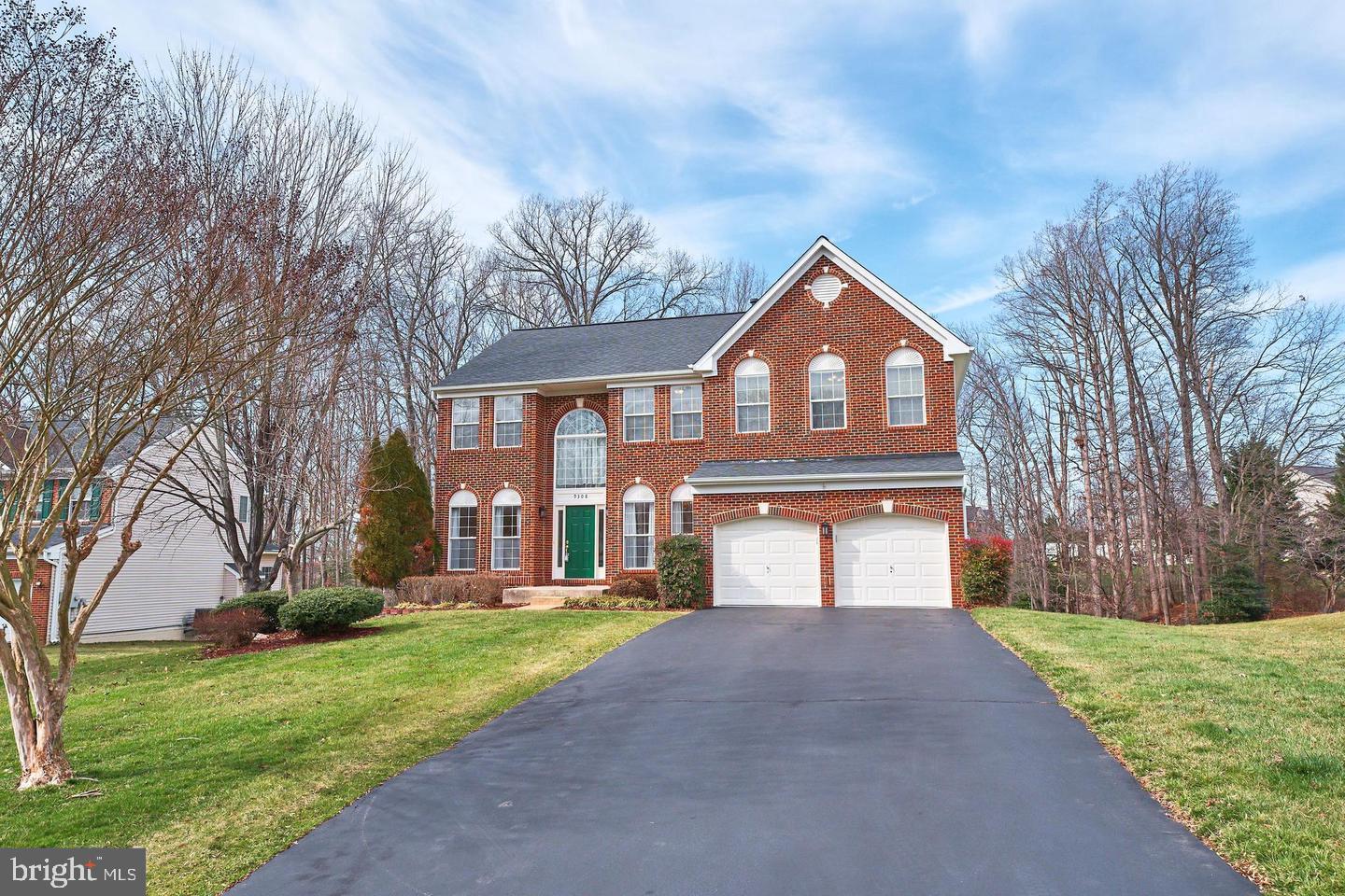 Beautiful brick colonial sits on a quiet cul-de-sac backing the trees. This house is the largest model in the sought-after Blooms Crossing community. The two-story foyer leads into a bright living room and a separate formal dining room that leads into the family room, and home office. The family room with a floor-to-ceiling stone gas fireplace is perfect for entertainment and gatherings. The spacious open kitchen with an island, an eat-in breakfast area, and a sliding glass door to the deck overlooks the natural scenery. The kitchen has 42” tall cabinets, granite countertops, glass tiled backsplash, stainless steel appliances (5-burner gas cooking range, double oven, dishwasher, double-door fridge), and a walk-in pantry. 9 ft ceiling and hardwood floors on the main level, New carpets on the upper floor, Ceiling recessed LED lights on all levels, new light fixtures, and water-saving elongated toilets have been installed. The upper level has an extra-large master suite with vaulted ceilings, and his and her walk-in closets. The master bath has a double sink vanity, a walk-in shower, and a separate soaking tub. There are four more spacious bedrooms with walk-in closets and a big shared bathroom. The deck has stairs to a paved patio and a gently sloping backyard surrounded by tall trees. It is perfect for outdoor living.  The bright walk-out basement with windows leads out to the patio. It has a full bathroom, two bonus rooms, and a recreation room.  A big walk-in storage closet, 2nd kitchen, and 2nd laundry room have been made recently in the basement. A maintenance-free walkway deck to the basement from the front of the house was recently built. Walk to a public elementary school and a private school, Blooms Park hiking trails, and a water park. Short distance to popular restaurants and shops on Liberia Avenue, route 28, and VRE station to DC. This amazing house is well-designed for living with in-laws or adult kids.