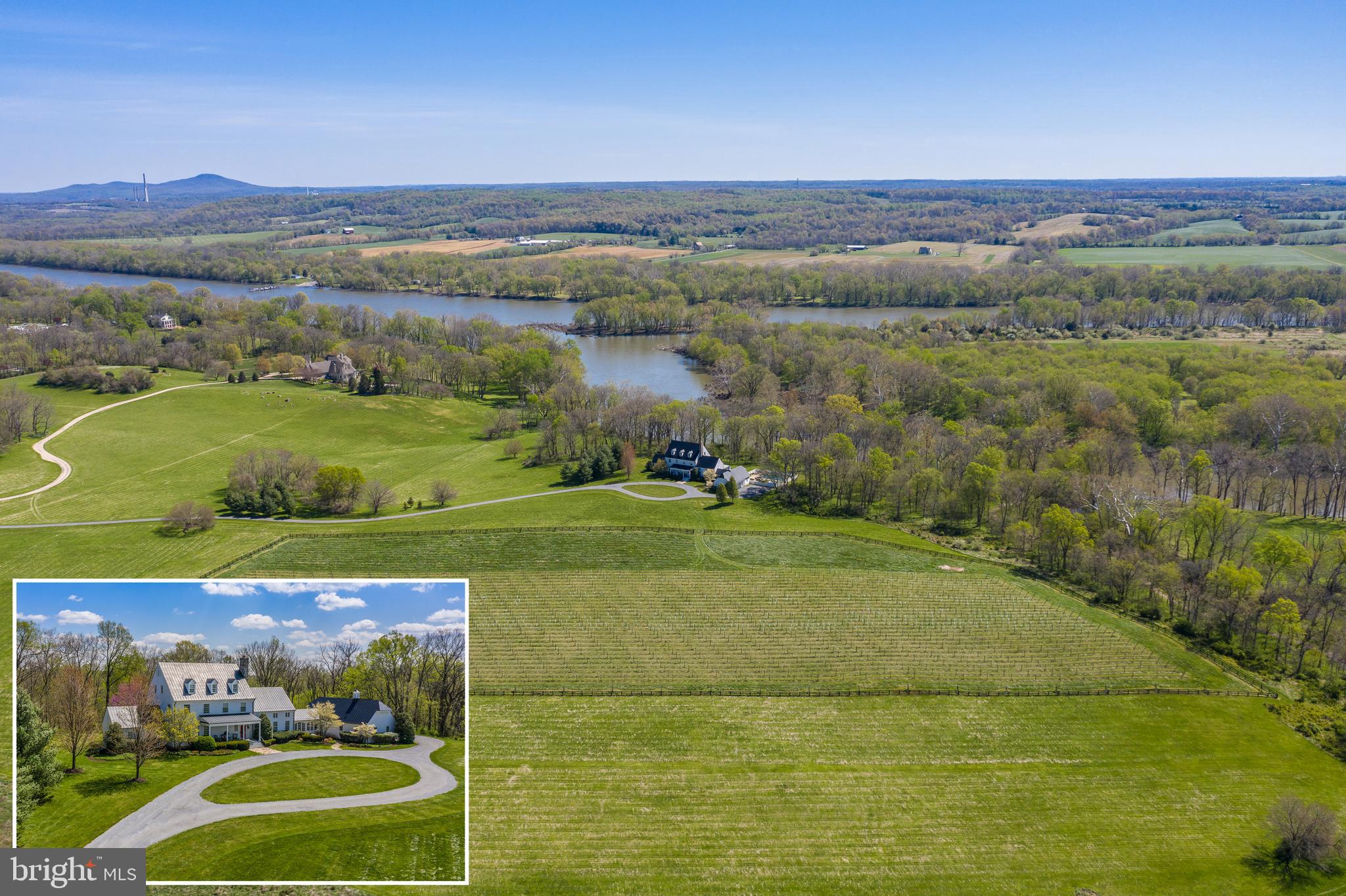 WHY DO BUYERS MOVE TO BEAUTIFUL LEESBURG IN LOUDOUN COUNTY - THIS IS WHY.  Appreciate this absolutely  stunning  36-acre haven in a setting on the Potomac River (waterfront) with a Mount Vernon feel and its own outdoor meditation area and a rare Trout Stream.   8 Acres of fenced property have  5 acres with new grape vines 2-3 years old.  There is also a 2-mile community foot path homeowners enjoy along with a gazebo/picnic area and park-like topography.  This quality-constructed, custom home one must see to appreciate.  Its design is filled with numerous sought-after amenities that will appeal to the most particular Buyers - a beautiful in-ground pool and spa, a must-see enclosed Plantation-Style Porch, a relaxing large front porch and swing, and its interior boasts an all-important main-level Owner s Suite in addition to 4 other large bedrooms upstairs with several other bonus rooms, a gym, media, library and unofficial bedrooms.    Fashioned in the farm house and National style with Geo-Thermal utilities, its uniqueness is something you do not find today with wood-beamed ceilings, moldings and designer niches throughout, including an expansive gourmet kitchen with farm sink, stainless appliances, organizational stations (a gorgeous pantry and full cabana bath off the breezeway near a rear exit by the pool) and tall, French doors all along the rear to take in this unmatched setting.  While touring, take note of the customized Owner s dressing area and closets, the whirlpool Jacuzzi pool, the breath-taking views out the numerous front and rear windows and the gorgeous, thoughtful touches in a home which is so rare to find.  Gorgeous woodworking, window casings and treatments - hardwood floors adorn the home while perfectly blending with its surroundings, bringing the outdoors in you will also see the two main-level offices as well as the expansive living/family room with ceiling-high views and access to the screened porch. Mature trees make way to grant beautiful views of the Potomac River which embrace and surround the senses as one takes in this special home and its placement   walk along the private path to the meditation area or continue to the Potomac on this property, or enjoy the foot path around the community.  Overall, this is a one-of-a-kind home and property - Buyers will stop and pause at its beautiful location so near downtown Leesburg in the private community of "Big Spring Farm" with horses in the community and this property ideal for them as well.  Near schools, restaurants/retail, wineries and horse country - this home is only 20 miles from Dulles Airport and close to major commuter routes.