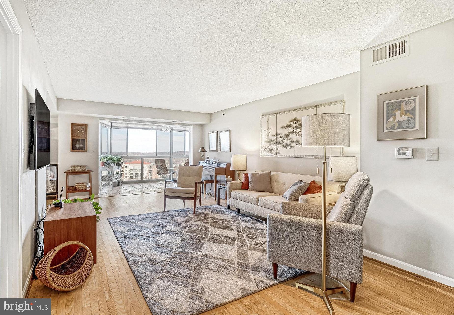 This highly desirable end unit is now available in the vibrant 55+ community of Lansdowne Woods for you to call home. Revel in this 2-bedroom condo, boasting 1,415 sq. ft. of living space, numerous updates and a reserved garage parking space.
    Hardwood floors welcome you into the grand living area which opens out to the sunroom. With neutral paint and beautiful natural light this room is ready for you to put your touch on. The separate dining room has access from both the living room and kitchen for easy entertaining.
    Get cooking in the kitchen where you will find an abundance of cabinets including some with glass fronts to show off your favorite pieces, granite countertops and stainless appliances. A window above the sink provides the light you need and a great view while tackling the dishes.
    The primary bedroom is a spacious retreat, complete with fresh carpet, an ensuite bathroom and two closets including a walk-in. The primary bathroom has room for two with a dual-sink vanity, a spacious walk-in shower, and plenty of storage.
    The second bedroom would be a perfect guest room or a comfortable home office with a door out to the sunroom and a wall of closets with custom built-in shelving. Just outside the bedroom is a recently updated guest bathroom with modern flooring, countertop, lighting and accessories.
    Beyond the bedrooms, a den off the living room awaits your creativity – whether you envision it as a library, a craft space, or a quiet reading nook, it's ready to fulfill your desires.
    The sunroom is designed to be the perfect spot to unwind with a cup of tea and the beauty of nature with views of the Potomac River and Sugarloaf Mountains.
    A convenient garage parking is reserved for you close to the door to the building so bringing in your groceries is a breeze. A storage space is also available to hold all your extras you need throughout the year.
    Resort style living is available at the gated community of Lansdowne Woods with an indoor pool, exercise room with all the latest fitness equipment, a full service restaurant/bar, tennis and pickleball courts, hair salon, library, ballroom, business center and so much more! Socialize with great people at community dinners, clubs, concerts and trips to area attractions. Located 15 minutes to Dulles Airport, and close to retail, dining and golf for even more weekend fun.