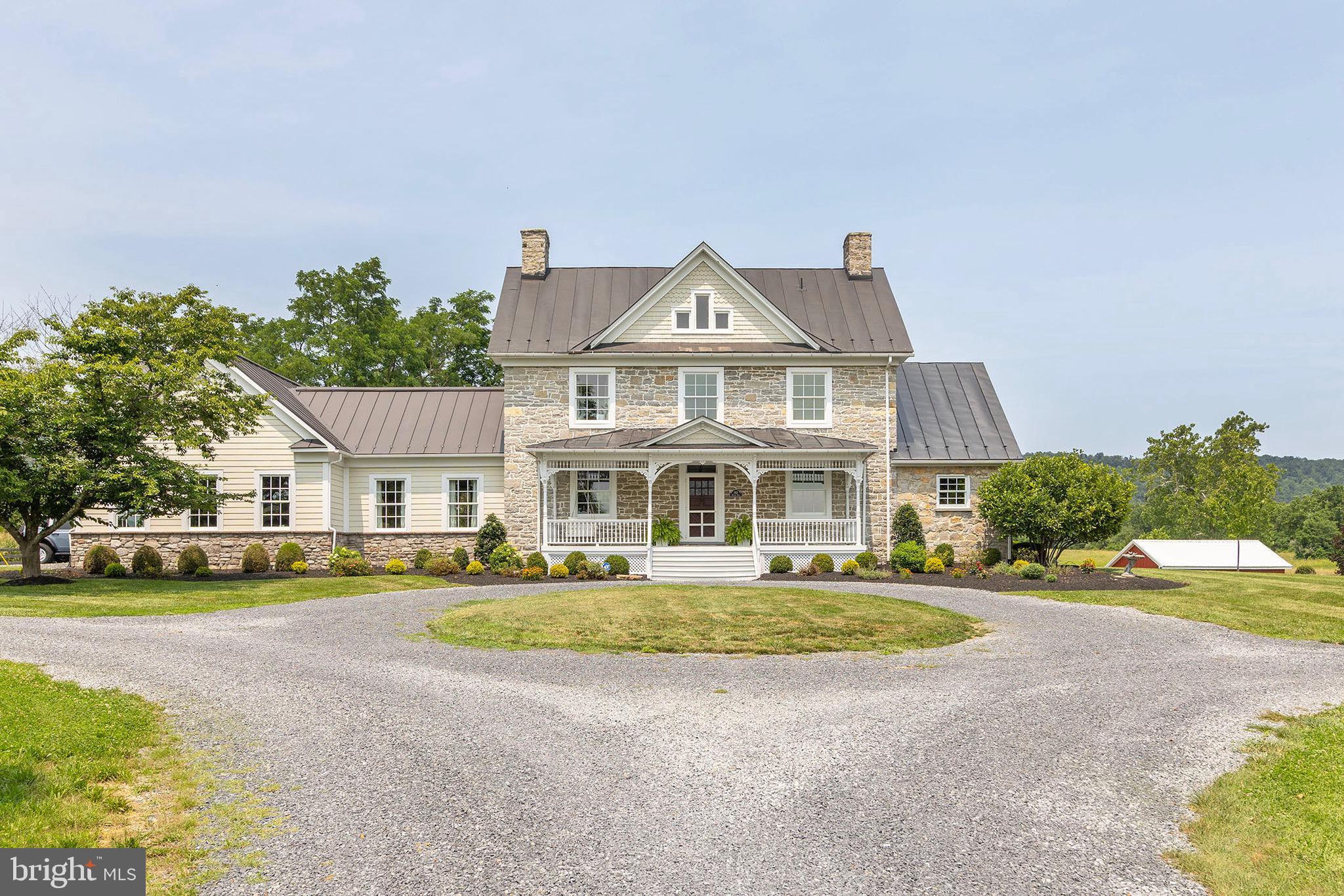 Built in 1774, before America was America, this remarkable 31-acre estate has stood through the birth of a nation, and today it's ready for its next chapter.  This is history you can live in, a piece of the past, built for the life you're living now. Hardwood floors run throughout, and the spacious kitchen opens effortlessly into the family room and dining space, the kind of layout that makes everyday living and entertaining equally easy, with direct access to either the back patio or covered side porch. Four bedrooms include a primary suite with its own private & covered porch overlooking the 31.74 acres and pond, a quiet spot to start or end the day. Additional flexible bonus rooms offer options for guest space, an office, or extra bedrooms as needed, alongside 3 full and 2 half baths across. A 3-car attached garage adds everyday convenience. Outside, the property opens into 31.74 sweeping, scenic acres. A picturesque pond anchors the grounds, a substantial 100' x 50' barn with its own electric service offers exceptional storage or workshop space, ready for hobby farming, equipment, or a creative studio of your own. Just 15 minutes to downtown Winchester and minutes from local attractions like the Museum of the Shenandoah Valley, with Washington, DC only 84 miles away, this is countryside living with the city still within reach. A rare chance to own a true piece of American history, lived in, loved, and ready for its next 250 years.