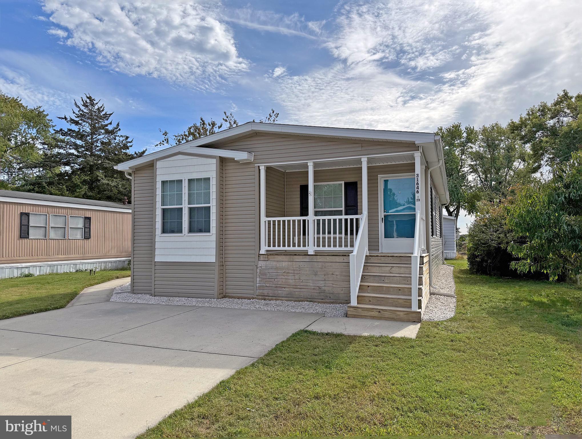 NEW PRICE  & Ready for immediate* occupancy! Spacious 2016 doublewide has new wide-plank, luxury vinyl plank flooring & has been freshly painted throughout. Covered 6’ x 14’ front porch. Eat-in kitchen has space for a large dining room table. The kitchen appliances include a fridge with ice maker, dishwasher, smooth-top electric range, and a built-in microwave. The laundry room is just off of the kitchen, and it has a door to the side yard. Full-size, side-by-side washer and dryer. The living room has windows on two walls for lots of natural light. The main bedroom is en Suite. That bath has a single-sink vanity, a linen cabinet, and a step-in shower with seats. The other two nicely-sized bedrooms share the second full bath in the hall. That bath has a tub/shower. This home is just around the corner from the community pool and playground. You’re just 5 miles to the Lewes public beach, with the Cape Henlopen State Park beaches a little farther away. And the Rehoboth Beach boardwalk is approx. 10 miles away. Whispering Pines also has access to the State Park’s hiking/biking trail so you can travel to downtown, historic Lewes and its beaches without having to get in a car! Whispering Pines rules allow two (2) pets, but no fences. Current leasehold interest is approx. $888.02/mt. (renews again July 1, 2026, with any increase capped as per 25 Del. C. Sec. 7050-7054). Lot rent includes trash/recycle, seasonal lawn service, and pool membership. Homeowner pays electric, water, sewer, and cable/Internet. Equity LifeStyle Properties, Inc., the community owner, requires an Application from the Buyer, with acceptance based on the following criteria: 1.)income verification, 2.)credit bureau score, plus evaluation of debt-to-income ratio, and 3.)criminal background check. (Note: Family & friends may always visit, but rentals are NOT permitted in this community.) Financing may be available to qualified borrowers from only a few Lenders that specialize in installment/chattel loans for manufactured homes on leased land. Closing costs will include a Delaware real estate transfer tax (3.75% DMV Doc Fee) & a Settlement Agent fee.