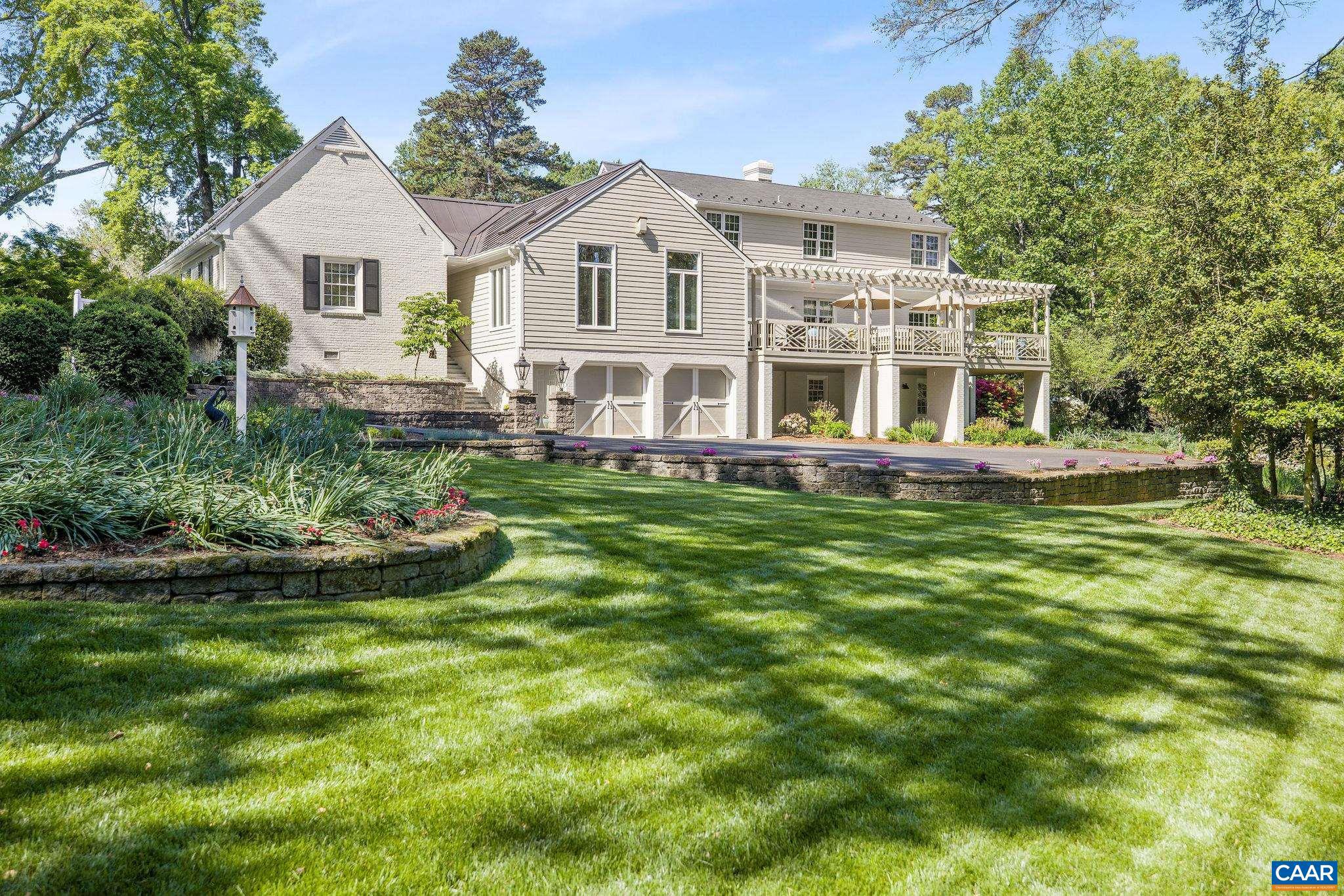 This brick home in Meadowbrook Hills features five bedrooms, five bathrooms, and a one-bedroom guest apartment on the terrace level. The living room boasts high wood beam ceilings and a cozy fireplace, creating a warm and inviting atmosphere. The kitchen is equipped with custom cabinets and a spacious island, ideal for cooking and entertaining. The expansive back deck and blue stone patio are perfect for outdoor gatherings, surrounded by beautifully maintained gardens and mature trees. What truly distinguishes this property is its generous yard space?a rare find in the city. The well-kept backyard offers a serene retreat, enhancing the indoor-outdoor living experience. It's an ideal setting for relaxation, gardening, or hosting friends and family. The guest apartment provides privacy for visitors and the flexibility to accommodate family or friends comfortably. It can also serve as a rental space for extra income or a private home office, making it a versatile feature. Other highlights include a two-car garage and thoughtfully designed spaces that blend style and functionality. This home offers a unique opportunity for anyone seeking a luxurious lifestyle in one of Charlottesville's most desirable neighborhoods.,Granite Counter,Wood Cabinets,Fireplace in Family Room,Fireplace in Home Office