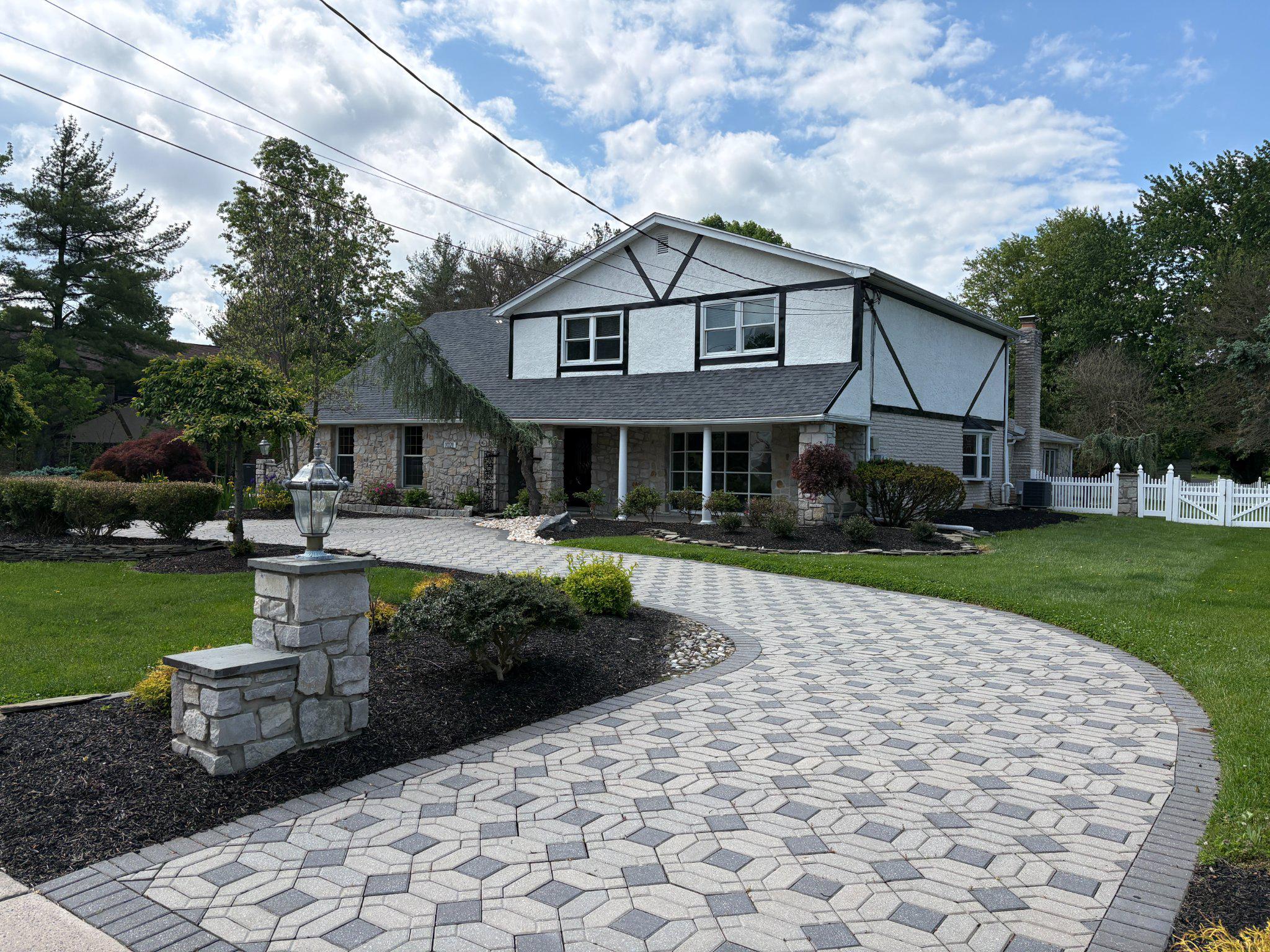 Upper Dublin single with lots of upgrades over the years. Great curb appeal with detailed paver circular driveway and landscaping. Koi pond in front by  stone walkway. Stone pillars with custom iron gates to enter back yard. Two car side entry garage. Extensive paver rear patio entertainment area. Featuring stone walls and built in hot tub.  Storage shed and mechanical awning over a large area for summer shade. New roof has been installed. Enter foyer with turning steps to second floor.  Large sunken living room with wide opening to formal dining room. Updated kitchen features new cabinets and appliances. Quartz counter tops and island. Rear recroom additions with doors to patio. Lots of natural light and cathedral ceiling. Stone fireplace. First floor laundry, powder room and home office. Could be used as fifth bedroom. Upstairs features include four bedrooms. There is a hall bath and full master bath. Master bath has soaking tub and stall shower. Full unfinished basement.