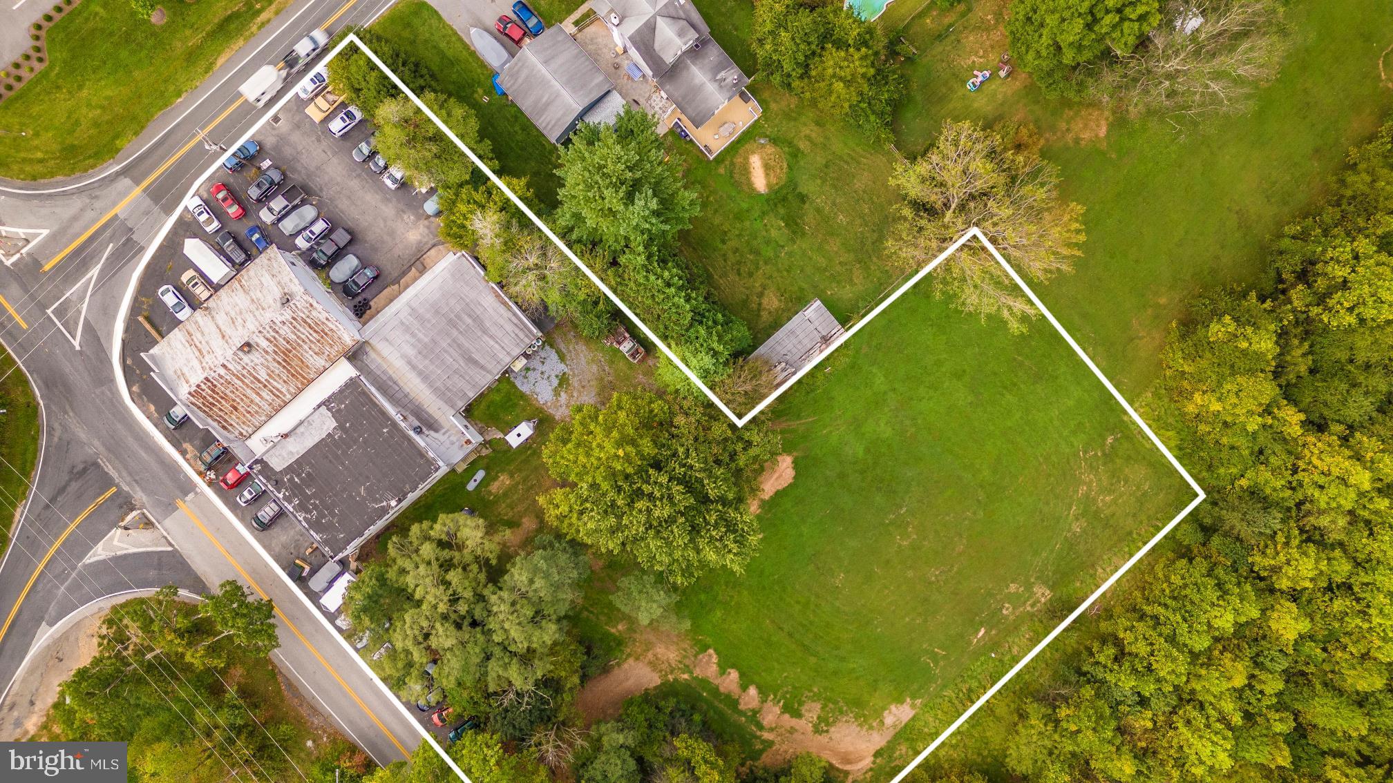 Massive 11,000 sq/ft building with 3 separate units on 1.76 acres of land with 1 acre being unused raw land on 600 feet of well traveled road frontage and zoned B2 with a multitude of business opportunities available under this zoning.  Lower level garage doors are 13 feet tall with 18+ foot ceilings and 4 vehicle lifts and upper level houses 4 vehicle lifts with 12 foot ceilings. Large vans and delivery trucks will access lower level garage effortlessly.  Owner has occupied the building for 27 years and has built up an incredible automotive shop and business.  All stationary equipment conveys including the 8 vehicle lifts.  All major systems have been completed and building has been very well maintained.  Amazing investment opportunity with fully built shop and land to expand!