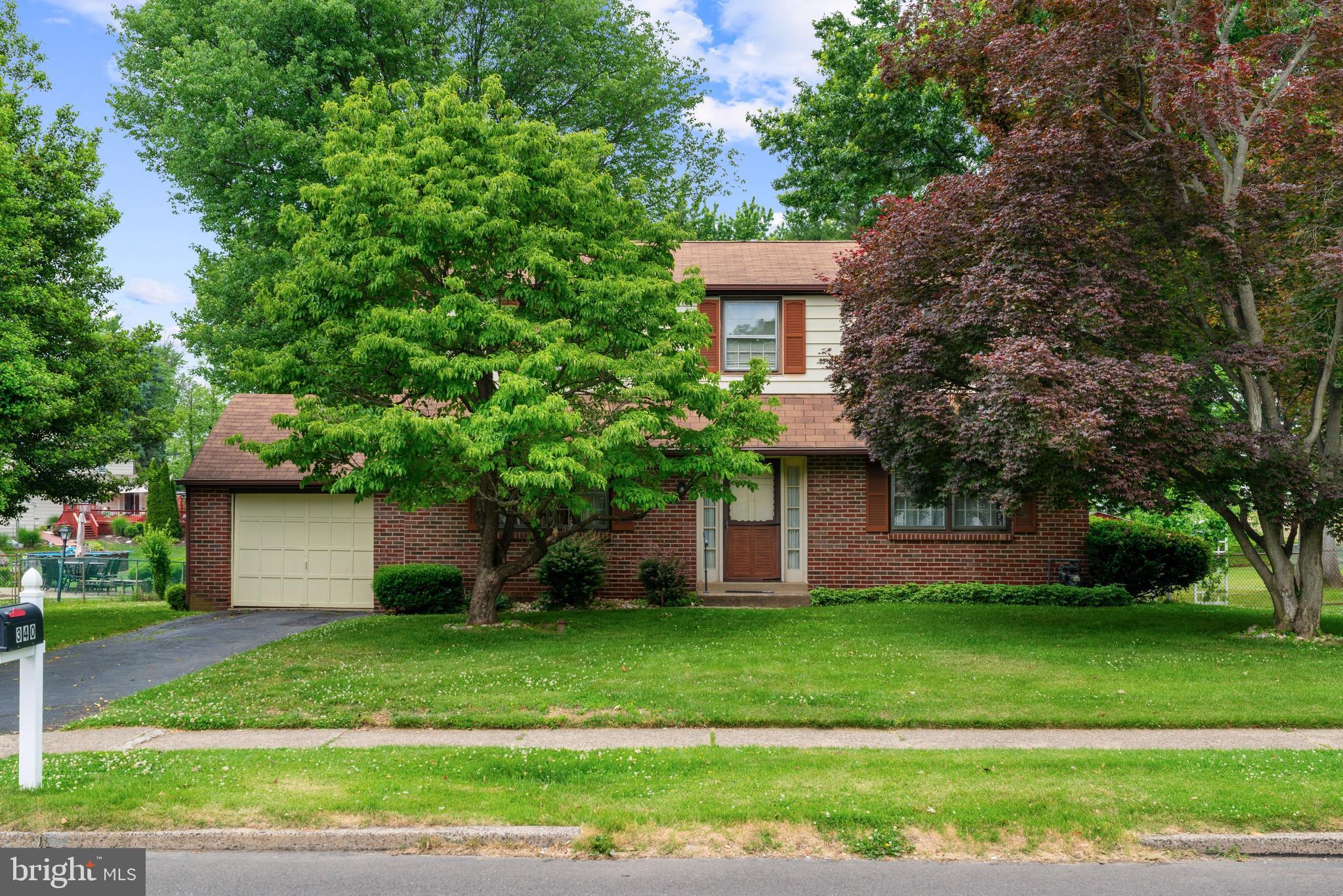 Welcome to this well loved, solidly built brick colonial set on a beautifully landscaped lot in the heart of Feasterville. The main level flows from a welcoming foyer into a bright formal dining room with rich hardwood floors, while the spacious living room is anchored by a classic brick fireplace.  The eat-in kitchen offers abundance of natural light along with a cozy breakfast nook. Completing the main floor is a convenient powder room and a separate laundry/mudroom with direct rear yard access. The large basement with tall ceilings offers an opportunity for extra living space, entertainment, and extra storage.   Upstairs, 3 generously sized bedrooms all feature hardwood floors, the upstairs hall is accompanied by a bath with a tub/shower combo. Outside, the rear yard is truly special,  a generous, park like space shaded by mature trees. The property also includes an attached 1 car garage with a paved driveway. Featuring exceptional curb appeal from both the front and rear, this home offers timeless bones and exciting potential for the right buyer.