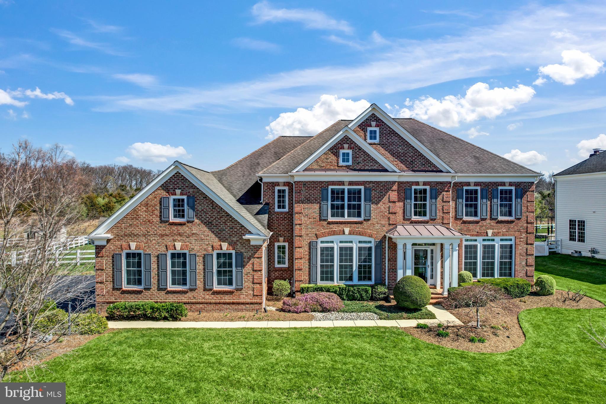 Prepare to be wowed by this spectacular Chatsworth model situated on a private lot backing to conservancy space in the highly sought-after Hamlets of Red Cedar! As you step into the impressive entry, you'll be greeted by high ceilings, crown and chair molding, and beautiful hardwood flooring on the main and upper levels, which flow seamlessly into the formal dining room and living room. The eat-in kitchen is a chef's dream, featuring a huge island, granite countertops, a stylish backsplash, ample cabinetry, and stainless-steel appliances, including a custom stove hood. The kitchen opens to a spacious family room with a coffered ceiling and a stone fireplace, providing the perfect setting for entertaining. Adjacent to the kitchen is a light-filled sunroom offering a private view, ideal for enjoying your morning coffee. A butler’s pantry with a beverage fridge leads to the mud and laundry room, complete with additional cabinetry and a sink for added convenience. The main level office, accessed via French doors, is tucked away for privacy and boasts built-in shelving and a wall of windows.

Upstairs, the Owner’s bedroom is a spectacular retreat with a trey ceiling, a sitting room with built-ins and a fireplace, and an ensuite spa bathroom featuring double sinks, a soaking tub, and a frameless shower. The HUGE walk-in closet with built-ins and additional space adds to the luxury.

The upper level also hosts three additional spacious bedrooms, each with its private bathroom, ceiling fans, and ample closet space.

The lower level boasts an open rec room finished with luxury vinyl flooring, perfect for a home theater, and a custom-built wet bar complete with a dishwasher and beverage fridge. Another bedroom and a luxury spa bathroom with an infrared sauna and steam room are also located on this level. Tons of additional storage is available, along with a finished room that can be utilized as a gym or crafting room.

Outside, the fenced-in backyard is a sanctuary with views of wildlife and open space. Enjoy the upcoming beautiful weather on the trex deck leading to the covered patio with power screens, multiple entertaining spaces, and a hot tub for relaxation. A custom shed provides convenient storage, while custom lighting and landscaping add to the appeal. The three-car side-load garage features sealed flooring. Community amenities include walking trails, an outdoor pool, and playgrounds. This fantastic property is conveniently located near shopping, dining, downtown Leesburg, Dulles Toll Rd, and Loudoun County Parkway. Get ready to live in luxury and enjoy the best of both indoor and outdoor living!