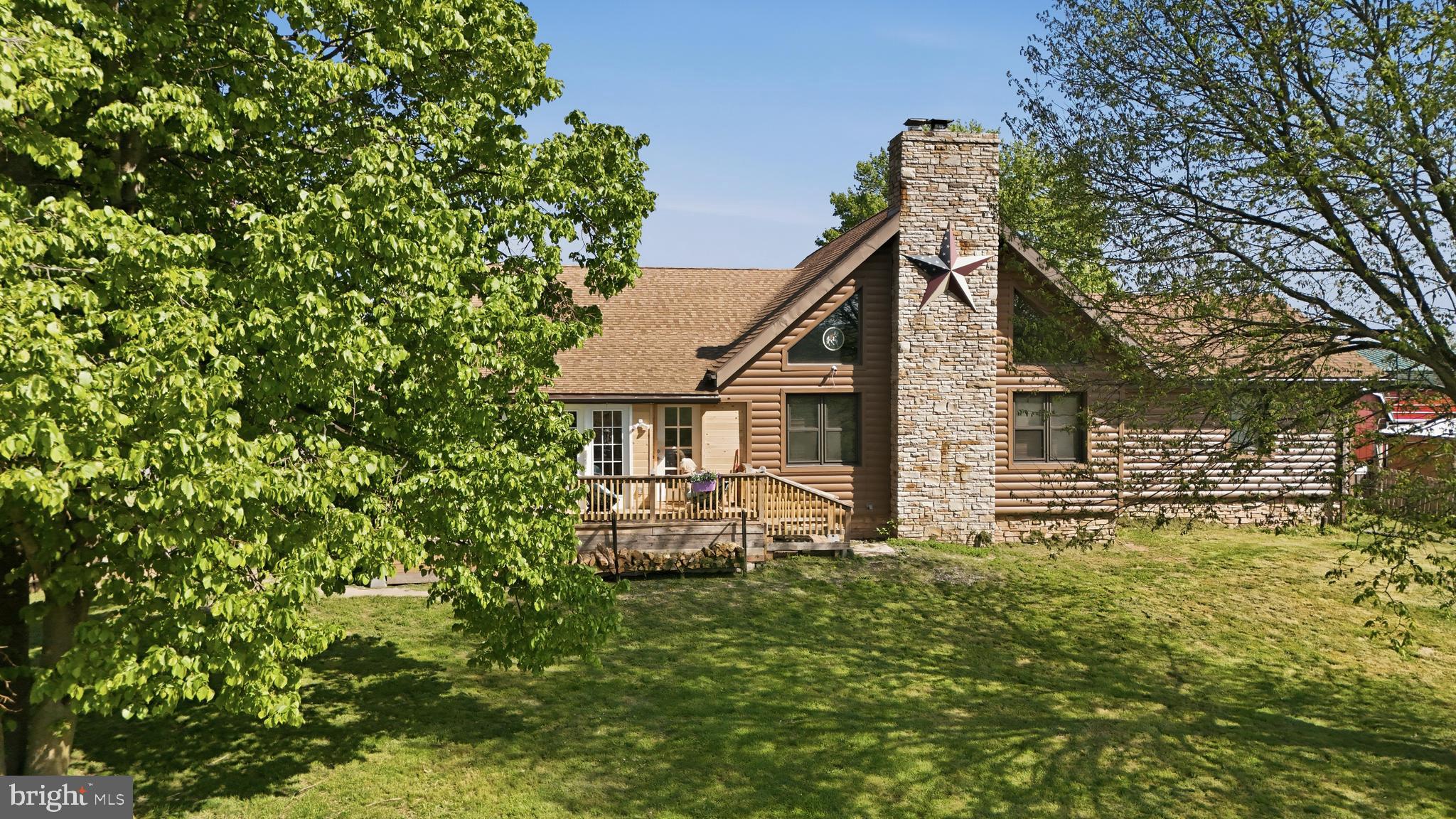 **Motivated Seller***New price, new pictures, you could be the new owner!!Turn-key horse property meets resort-style living in this fabulous custom-built log home set on over 5 acres of land with mountain views. Spend your mornings in the saddle and your afternoons by the saltwater in-ground pool (installed 2020), all in a setting designed for both everyday function and unforgettable gatherings.

The equestrian facilities are established and in active use. The property features a 90 x 70 riding arena positioned in front of the pole barn, 65’ round pen, a 39’ x 41’ pole barn with electric and water including feed room, tack room and hay storage, plus an additional 4-stall horse barn with electric and water. Property also hosts a chicken coop and duck area, goat pen with shelters, and a fenced area for household pets in the front of the home. In addition, a complete electric fence surrounds most of the property.

The kitchen is the heart of the home with custom cabinetry, stainless steel appliances, and generous counter space for cooking, seating, and entertaining. Enjoy immense storage, slide-out pantry space, and an additional eat-in area, currently styled as an office and coffee bar. Just off the kitchen, you will find a seasonal sunroom/enclosed porch filled with lots of natural light and beautiful views.

The great room delivers the wow factor with cathedral ceilings, exposed rafter beams, and a dramatic wood-burning floor-to-ceiling stone fireplace. Upstairs, the loft-level bedroom, currently used as a game room, overlooks the open and airy great room below.

An oversized primary suite featuring a walk-in closet and a private en-suite with a unique custom-tiled walk-in shower and separate soaking tub. Another main-level bedroom and a second full bath offer flexibility. The second bath features a walk-in shower and convenient dual access from both the kitchen and the second bedroom.

Everyday function is built-in with a main-level laundry room, and the convenience of central vacuum! The lower level offers a finished flex space ideal for a den, playroom, gym, or media lounge, plus over 2,000 sq ft of unfinished storage divided on both sides of the finished area, plus a second washer and dryer. Find in lower level a radon remediation system, water softener, and UV water purifier. An oversized detached garage adds even more flexibility, with an electric vehicle charger, 50 amp RV hookup, and an attached finished office or work space with high-speed commercial internet. Ideal for hobbies, a studio, or a home-based business. Private shooting range on property.

A rare combination of proven equestrian function and staycation-worthy outdoor living, all in a beautiful mountain-view setting. Schedule your tour today!