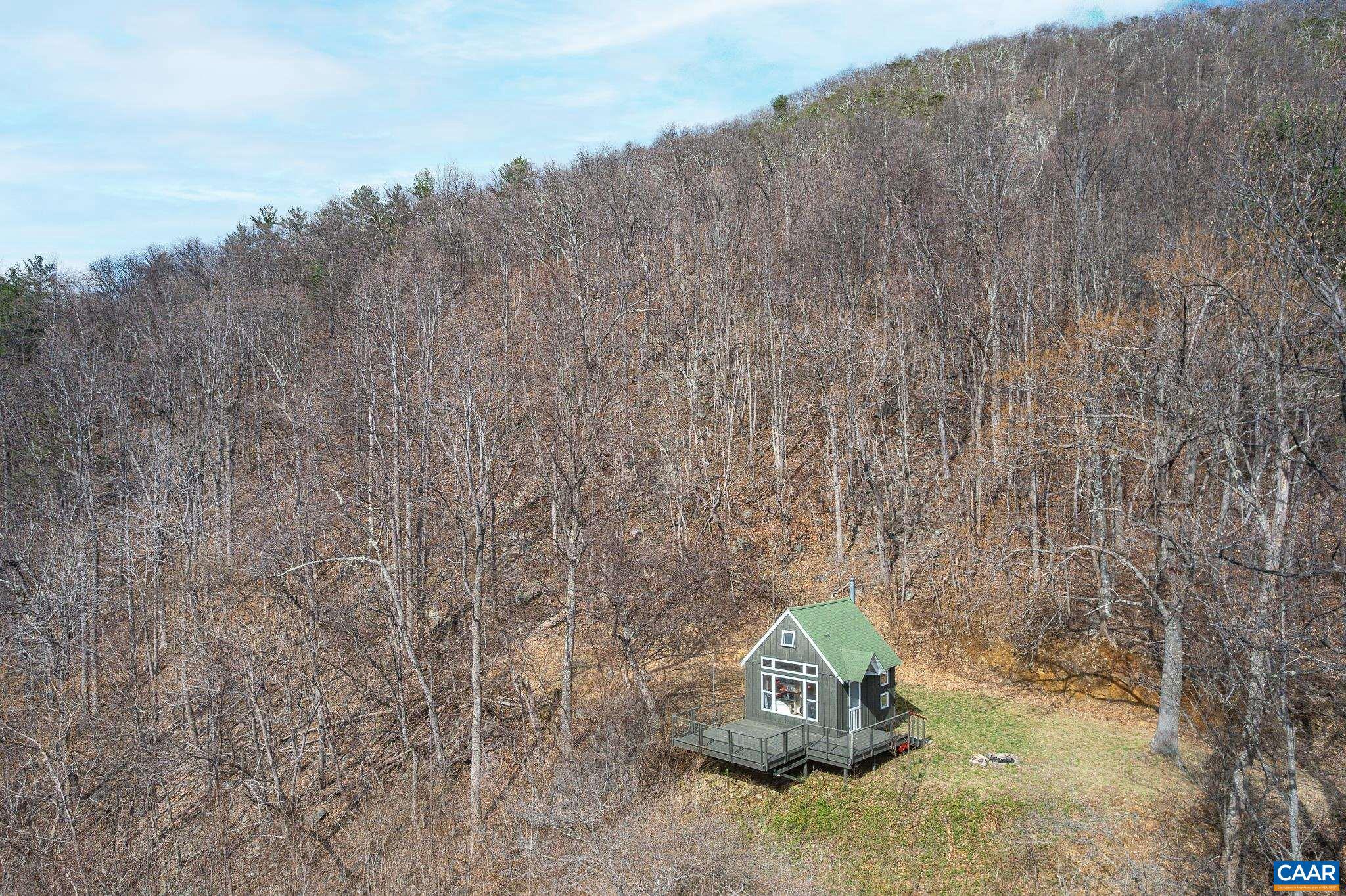 This extremely secluded 37.07acre parcel with potential for a full time residence, sits at the end of a private road high above Crabtree Falls Hwy in Tyro, Nelson Co. Nestled in a clearing on the south side of the mountain at the end of the driveway is a small cabin. From the deck enjoy stunning views of the Priest & out across the valley below, far into the distance. A perfect location for outdoor enthusiasts, hiking or hunting on the property or the adjoining National Forest to the north, trout fishing in the Tye River, or walking on the Appalachian Trail, just a 5 minute drive away, or a hike up through the woods. No well, septic or power on the property so you are really glamping here! Enjoy the woods but be warm and dry whatever the weather thanks to the woodstove in the cabin. Located approx. 20 mins from Lovingston for grocery store, banks, restaurants, breweries and more, and also 20 mins to the VA151 breweries etc. An easy 45 mins drive to Lynchburg and 1 hr to Charlottesville