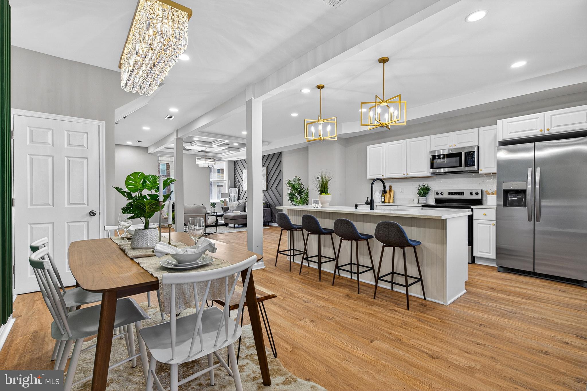 Welcome to Sophisticated Urban Living at Its Absolute Finest.
Prepare to be captivated by this masterfully reimagined, fully transformed rowhome that effortlessly blends classic Baltimore architectural charm with high-end, contemporary luxury. Spanning three fully finished levels, this expansive 5-bedroom, 3.5-bathroom masterpiece has been completely renovated from top to bottom with an uncompromising commitment to detail, design, and quality craftsmanship.
From the moment you step off your classic covered front porch and through the striking black entry door, you are greeted by an expansive, sun-drenched open-concept main floor. Rich, wide-plank wood flooring stretches underfoot, complemented by crisp recessed lighting and crown molding throughout.
The true showpiece of the formal living room is a magnificent custom geometric accent wall, beautifully framed by an architectural tray ceiling with contrasting slate-gray inlay and a dazzling crystal chandelier. It is a space designed strictly to impress.
A Chef’s Dream Kitchen, Flowing seamlessly from the living area is the stunning gourmet kitchen, meticulously engineered for both casual dining and upscale entertaining. Features include:
An oversized waterfall quartz island with breakfast bar seating and a deep undermount sink.
Premium, bright white shaker cabinetry paired with contemporary gold hardware.
A classic, brilliant white subway tile backsplash.
Top-of-the-line stainless steel appliances, including an over-the-range microwave and a smooth-top electric range. A perfectly positioned, elegant powder room just off the main living area for guests.
Ascend the striking open staircase to discover bright, oversized bedrooms boasting ample closet space and brilliant natural light. The bathrooms are true spa-like sanctuaries, showcasing custom floor-to-ceiling porcelain tiling, sleek matte black fixtures, custom floating vanities, and premium glass-enclosed walk-in showers. The fully finished lower level offers tremendous versatility, presenting the perfect layout for a private in-law suite, an expansive media room, or a dedicated home office, complete with its own full, custom-tiled bathroom. The rear of the property elevates city living with a highly coveted, secure private parking pad that comfortably accommodates two vehicles.
No detail was spared, and no expense was spared in bringing this remarkable property to life. Located just moments from local amenities, commuting routes, and parks.
Schedule your private tour today and experience the pinnacle of Baltimore luxury living.