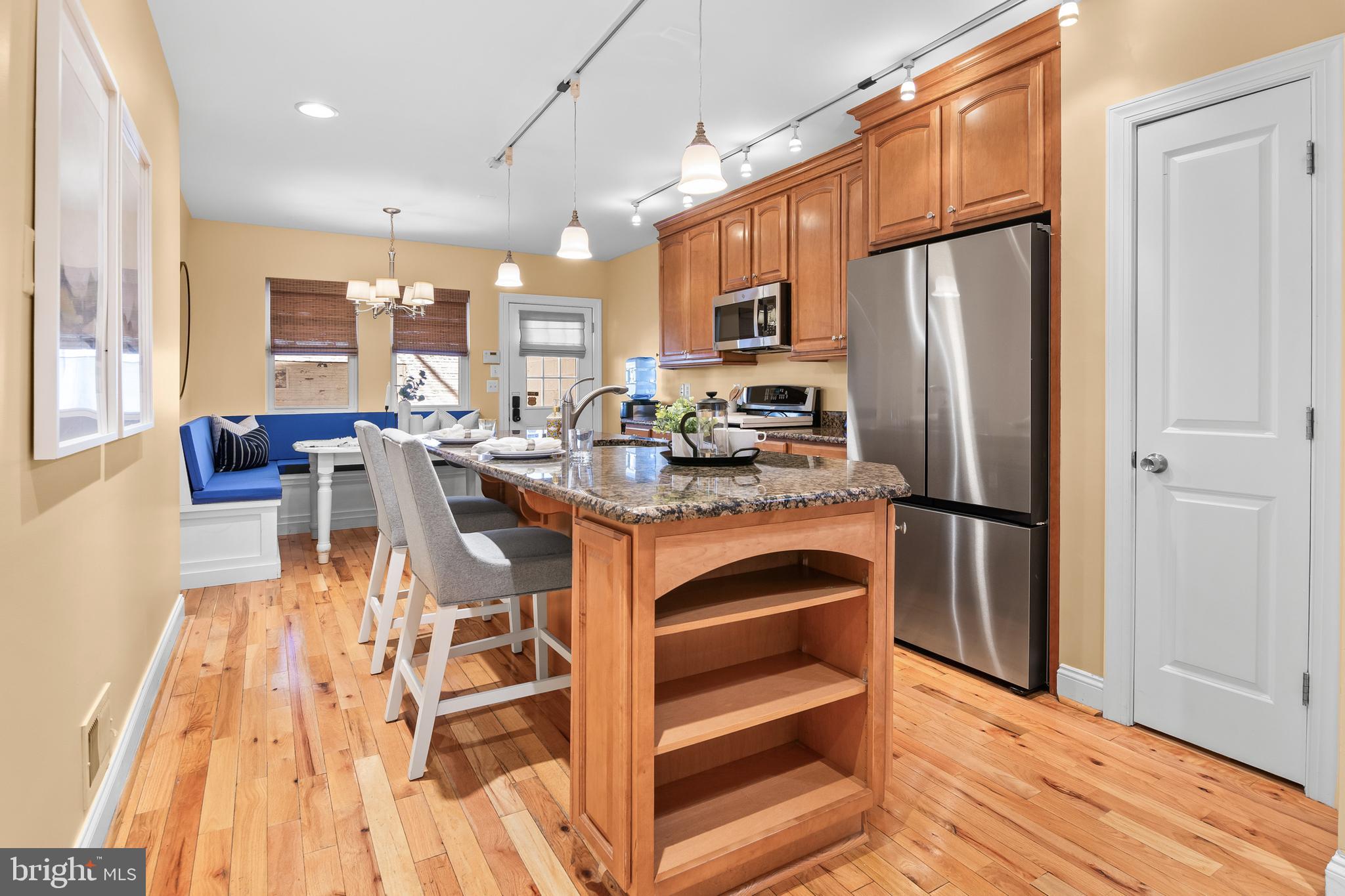 Open House Sun June 7th 11-1! You can't judge a book by it's cover. Similar to you can't judge a row home by just the facade. This is not a typical Baltimore city row home as you see it from the outside - this home offers over 3,500 finished square feet spanning across 4 levels + OFF STREET PARKING + oversized roof top deck with one of the best skyline views I've seen in a while.  Step inside to a front living room with tasteful arch wall interior designed feature and a gas fireplace. Moving back to the massive kitchen with large island and built-in dining room table in the rear of the home. You could easily entertain 10+ guests around this kitchen space - there's even a built in cabinet for wine and liquor! Schedule that summer house warming party now. Of course, there's a 1/2 bathroom on this level for added convenience.  The home has 2 upper levels + roof top deck level. Upper level 1 has 2 bedrooms, hallway full bathroom, hallway laundry, and hallway storage closet. Upper level 3 offers the ideal master suite with a bedroom, huge ensuite bathroom (shower + separate soaking tub), walk-in closet, and a space for a home office/den (maybe a future wet bar) with exterior door leading to roof top deck access. Enter up the spiral staircase to the true show stopper of this property - an extremely large roof top deck, I swear you could play corn hole up there. It really offers an unbeatable private oasis with panoramic city skyline and harbor views, creating the perfect backdrop for summer nights and Fourth of July fireworks. What a cool feeling to be able to relax perch up on top of your house you are proud to call your home!  The home is complete with a fully finished basement with fully ceiling height. It could be your home theatre for movie nights, sports watch zone , gym, or however you imagine this space. This home is perfectly positioned in the heart of Canton with easy walking distance to Canton Square, the Harbor Promenade, and Patterson Park.