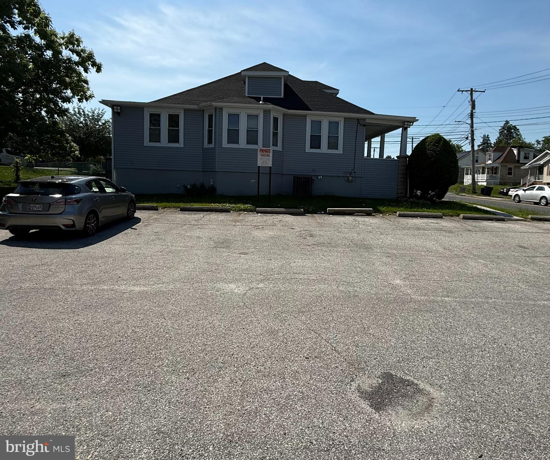 This versatile commercial space offers 3 exam rooms, 3 private offices, 2 bathrooms, and a kitchen area, making it ideal for a variety of professional or medical uses. The property also features additional upstairs space that can be utilized for expanded operations, along with a full basement providing ample storage. Accessibility is enhanced with an ADA-compliant ramp, and the large parking lot offers 15 dedicated parking spaces for clients and staff convenience.
