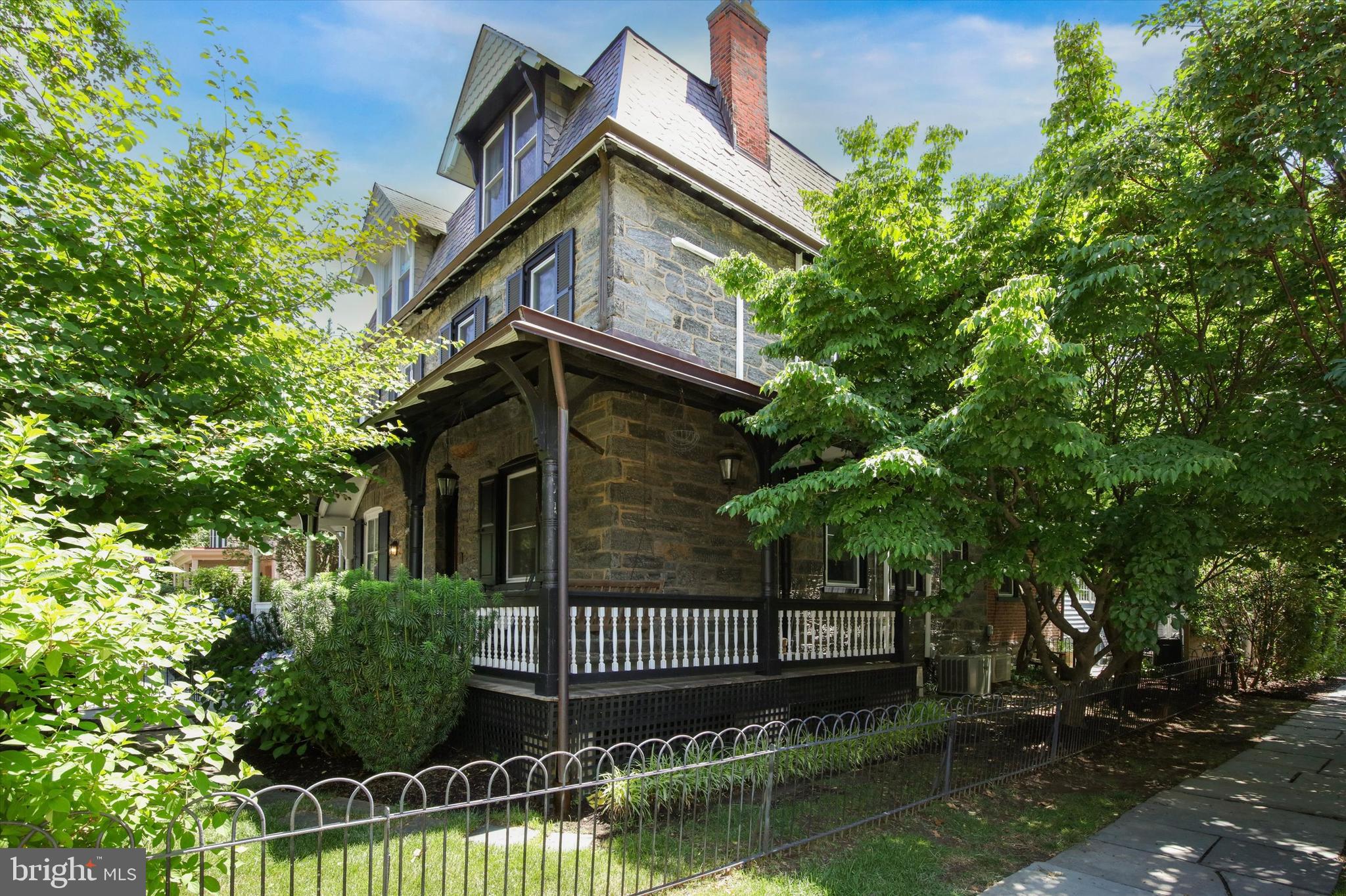 Welcome to 50 W. Highland Avenue, a beautifully restored 1925 Victorian twin in the heart of Chestnut Hill. This exceptional home blends timeless architectural charm with modern updates and features a welcoming wrap-around porch, solid stone exterior, original woodwork throughout, a private two-car driveway, and extensive interior and utility upgrades.

Pride of ownership is evident at every turn. In 2017, the current owners completed a comprehensive renovation, including opening the main level to create a spacious living, dining, and kitchen area, fully updating all bathrooms, removing knob-and-tube wiring and upgrading the electrical system, installing new windows throughout, expanding the rear paver patio, and adding a French drain in the basement.

Step inside and be captivated by the home's classic details and thoughtful design. Original hardwood floors, beautiful millwork, designer wallpaper, and curated lighting create a warm and sophisticated atmosphere. The open-concept main level seamlessly blends historic character with modern living, highlighted by an original wood-burning fireplace and antique brick accent surrounding the main support beam.

The first floor features a cozy formal living room with fireplace, spacious dining area, and a stunning chef's kitchen with custom cabinetry, premium countertops, and a professional-grade range. A rear den or study provides the perfect space for a home office, reading room, or family retreat, complemented by a beautifully designed powder room. From the study, step outside to the private rear yard featuring an expanded paver patio, lawn area, and garden shed. The fully fenced yard offers exceptional privacy and is ideal for outdoor entertaining, gardening, and pets.

Upstairs, the second floor serves as a luxurious primary suite, complete with a spacious bedroom, oversized walk-in closet(can easily convert back to the 2nd bedroom), two fully renovated bathrooms, and a convenient laundry closet. The walk-in closet was originally a second bedroom and could easily be converted back if desired.

The third floor offers two additional bedrooms with ample space for family, guests, or flexible work-from-home needs. The unfinished basement provides abundant storage space and room for a workshop or hobby area.

A rare opportunity to own a thoughtfully updated Victorian home in one of Philadelphia's most sought-after neighborhoods, just steps from Chestnut Hill's shops, many restaurants, parks, the Philadelphia Cricket Club and just 2 blocks to the train station!  Don't miss out, schedule your private showing today!