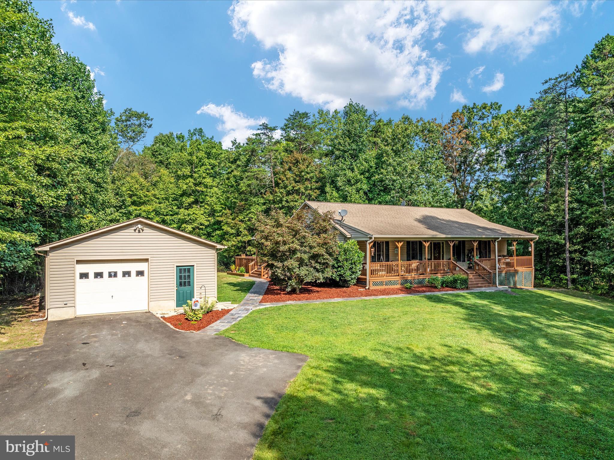 Nestled on over 7 acres of picturesque land, this beautifully maintained home offers 3 spacious bedrooms and 3 full bathrooms, including a luxurious primary suite. The lower level is fully finished and features a grand great room, along with two additional versatile rooms perfect for an office or non-conforming bedrooms. The home is equipped with a new HVAC system, sump pump, hot water heater, pressure tank, washer, dryer, stove, and refrigerator. It is also wired for an entire-house generator, ensuring peace of mind no matter the weather. Enjoy the outdoors with your own private creek, walking trails, and manicured landscaping. Relax on the large back deck, complete with an awning and hot tub, or unwind on the expansive front porch with two charming porch swings. The property also boasts a detached 2-car garage with a cedar-lined closet and a storage building, both equipped with electricity.  Wide hallways and ample closet space throughout the spacious bedrooms add to the comfort and convenience of this home. The paved driveway leads you through the beautifully landscaped yard, providing a warm welcome each time you return. Located just minutes from Sperryville, Skyline Drive, and Culpeper, this property offers the perfect balance of privacy and accessibility. Whether you're seeking a peaceful retreat or a charming residence, this home has it all. Hot Water Heater Replaced-50 Gallons-2018***Pressure Tank Replaced-2019***Sump Pump Replaced-2019***HVAC Replaced-2019***Roof-Works (Roofing Company) Replaced Fascia Boards and Extended Shingles for Water Run Off-Roof is on Good Condition and the Gutters are in Excellent Condition-2024***Wash and Dryer Replaced-2022***Refrigerator Replaced-2022***Stove Replaced-2023***House is wired for Whole House Generator***Electric Bill-Winter Months November-April-$280.00 a month/Spring-Summer Months-$180.00 a month***Wi-Fi-Piedmont Broadband-$79.95 a month-Seller at times works from home. ***ADT System is installed, but seller has never used the system***Garage & Shed Have Electric-Garage Has a Cedar Lined Storage Closet