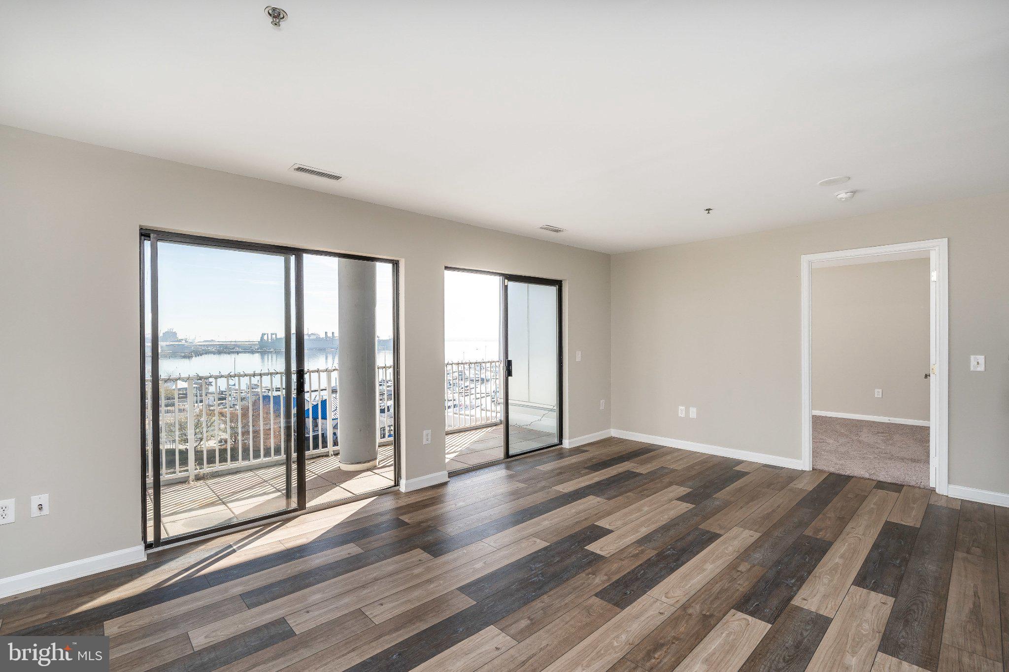 Prime water view location in popular Canton neighborhood.  Parking included.  24-hour desk, secure, elevator building.  Unit has gorgeous full water views from ALL rooms.  Rustic wood flooring in living space with granite and stainless kitchen.  Giant walk-in closet in primary bedroom.  Double slider leads to balcony that's the full width of the living space.  Ground floor of building offers a variety of restaurants and stores, including a yacht brokerage.  Super convenient to get to O'Donnell square, Safeway across the street, right on the waterfront promenade.  The only thing better than the location of the condo are the views!  Urban living at its best.