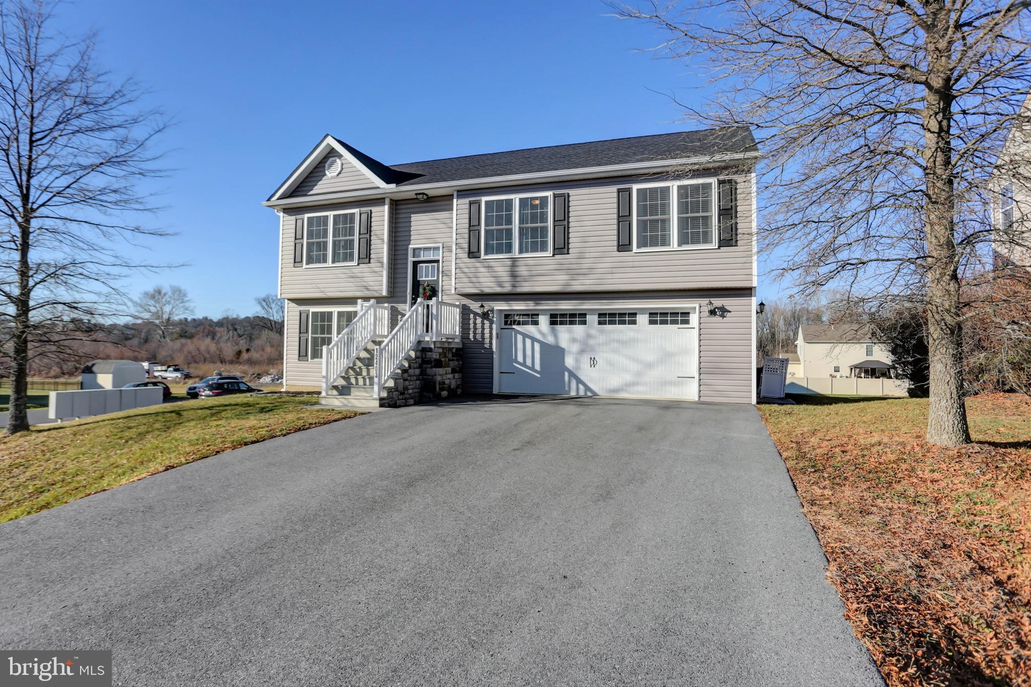 Welcome Home to this Comfortable and Cozy Split Foyer! Features include 3 bedrooms, 2.5 baths, finished lower level and 2 car garage. Open concept space creates a bright and sunny area between kitchen, dining area and living room. Kitchen has LVP flooring, a great center island with seating, stainless steel appliances and spacious dining area. Sliding door opens onto maintenance free deck. Primary bedroom has en-suite full bath with shower.  Two additional bedrooms with nice closets and can double for office space if you need area for work at home space. Finished lower level includes tile flooring, separate laundry room, half bath, recreation room and a sliding door out to the rear yard. Two Car Garage is deep enough to fit a full sized pick up truck. All appliances convey. This home present "Like-New"....why wait to have one built!? Showings begin Friday 12/15.