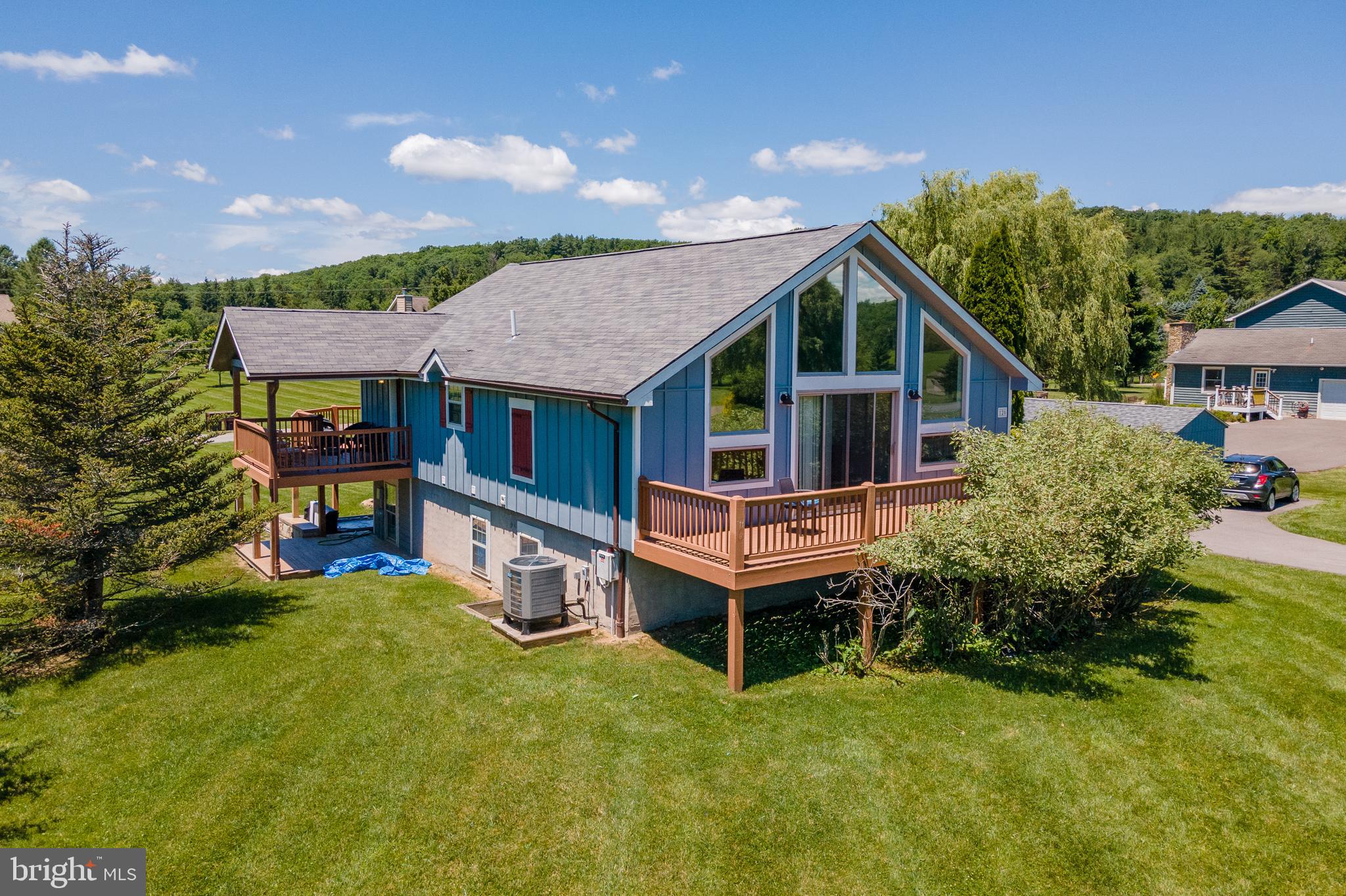 Recently renovated 4 BR 3.5 Bath chalet with lake access and located conveniently to everything Deep Creek and Garrett County have to offer.  The open floor plan offers plenty of natural light, pleasant views two fireplaces and two separate living areas.  With 2 primary suites, the property is ideal for multi-family use and enjoyment.  Located within minutes of Deep Creek Lake State Park, Thousand Acres Golf Club and most of the area's favorite restaurants and shops, you'll always be close to just about everything you may need or desire.  

With 2 decks,  covered porch, level lawn, fire pit, Hot tub, private roads and dedicated lake access areas, your outside experiences will be as enjoyable as your times inside.  

The property has deeded lake access located in a park like setting that is perfect for kayaking, swimming, or a picnic.