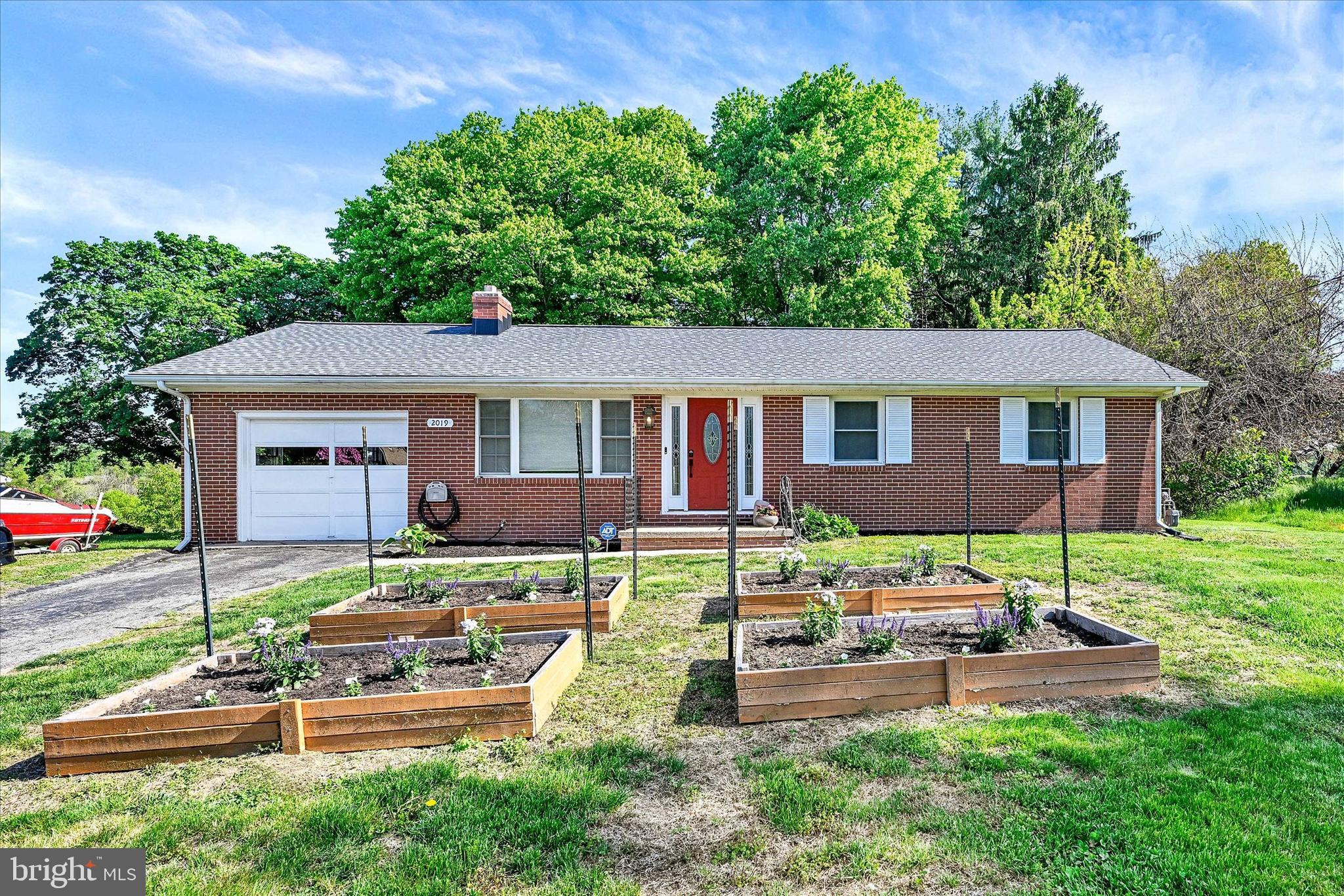 Back on the market! Welcome to this all-brick rancher with attached one-car garage, ideally situated backing to peaceful open farm land offering privacy and scenic views. The home welcomes you into a living room with hardwood floors, setting a warm and comfortable tone the moment you enter. From there, the layout flows into a large country kitchen featuring stainless steel appliances and granite countertops, offering plenty of space for everyday cooking and gatherings. The main level includes three bedrooms, all with hardwood flooring, along with a full bath. The floor plan is simple, functional, and easy to maintain, ideal for convenient single-level living. The basement has a finished room that could be used as a gym or additional living space. It is complete with a French drain and sump pump already in place. The rest of the basement is ready for your finishing ideas and offers the opportunity to nearly double the home’s usable square footage. Significant improvements have been completed throughout the home, including a water filtration system installed in 2023, an electrical panel in 2024, and HVAC in 2020. The shed is sold as-is. With so many major updates already completed, this home delivers comfort, efficiency, and long-term value in a quiet country setting.