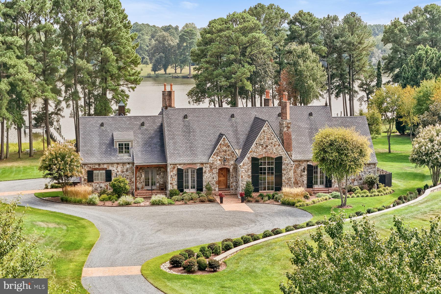 This beautifully refined stone and brick French country home crafted by Ilex Construction, is ideally situated between Easton and St. Michaels and rests on over 4 acres along the scenic Tred Avon River. Spanning approximately 4,500 square feet, this meticulously maintained residence features 4 bedrooms and 4.5 baths.

The gourmet kitchen is a chef's dream, equipped with high-end appliances, gas cooking, a spacious island with seating, and an expansive walk-in pantry. The kitchen seamlessly flows into the large family room, which boasts a vaulted, beamed ceiling and a cozy gas fireplace. The separate dining room, also with a beamed ceiling, offers convenient access to a wet bar, making it perfect for entertaining.

The main level is home to a luxurious primary suite complete with a beamed ceiling, gas fireplace, and French doors that open to a poolside patio. The spa-inspired bathroom features a spacious walk-in shower, a separate soaking tub, double vanities, and a generous walk-in closet complete with a central storage island.  Additionally, this level includes a formal living room, a home office, a laundry room, and an ensuite guest bedroom.

Upstairs, you'll find two additional ensuite guest bedrooms and a spacious bonus room, offering ample space for family and guests. 

Outdoor entertaining is elevated to new heights on the expansive covered terrace, featuring a vaulted, beamed ceiling, gas fireplace, fans, and heaters.  The property’s heated saltwater pool, complete with an attached spa, invites relaxation. Other noteworthy features include an attached 3-car garage, a 30x15 shed, an encapsulated crawl space, a fenced backyard, a dock with water and electric, boat and jet ski lifts with approximately 5 ft MLW, a 40-zone irrigation system with remote control, and approximately 245 feet of waterfront with a natural shoreline.
 
Easton, Maryland, known as the New Hamptons of the Chesapeake Bay by Forbes Magazine, is conveniently located 1.5 hours from D.C. and Baltimore, and 2 hours from Philadelphia. Fort Stokes Lane is just minutes from fine dining, shopping, healthcare, theatres, galleries, museums, golf courses, a country club, a yacht club, and a jet airport.
