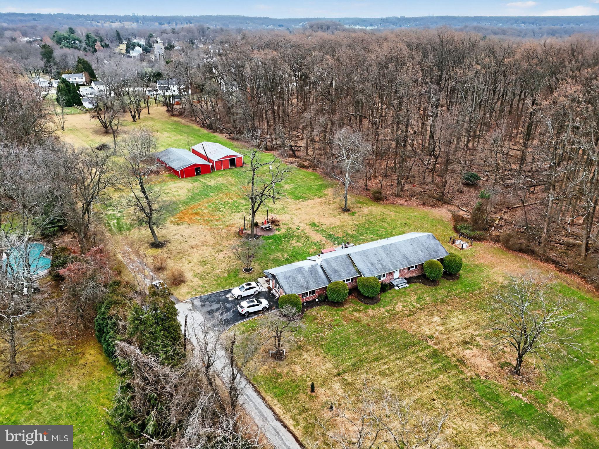 Set on an expansive 5.01 acres of flat, open land in the highly desirable Ambler/Maple Glen, 1637 Dillon Road presents a rare opportunity for developers, investors, or end users seeking future upside. The property’s A-Residential zoning and generous acreage offer strong potential for subdivision into approximately .6-acre lots, ideal for new construction homes in a market where comparable new construction properties command $1.8M–$2M+ price points.  Alternatively, the property lends itself beautifully to an equestrian estate or private family compound.
The land is a standout feature—mostly cleared, level, and gently rolling, with minimal tree coverage, allowing for efficient site planning and construction. A small creek at the front of the property, classified as wetlands, has minimal impact on the usable acreage, while the side of the property backs to township-owned wooded land, ensuring privacy and protection from future development. Public water and sewer connections are available along Dillon Road, further enhancing development feasibility.
The ranch- style residence on the property offers approximately 3,271 square feet of living space, featuring three bedrooms, two full bathrooms, and a half bath. Upon entry, you are welcomed into a formal living room—currently used as a game room—which flows into the formal dining room and an updated kitchen with granite countertops. A hallway to the right leads to three well-proportioned bedrooms and a full hall bath, including the primary suite with an ensuite bathroom and a generous walk-in closet. On the left side of the home, two expansive family rooms/Den provide excellent entertaining space, one highlighted by a wood-burning fireplace, and the other offering a bar and half bath.
 Once a horse farm, the property retains its equestrian roots with two pole barns featuring stables, offering the opportunity to restore the land’s heritage or repurpose the structures for storage or future use.
Located within the award-winning Upper Dublin School District, the property combines strong market demand, a premier suburban setting, and long-term development potential. With limited large-parcel opportunities remaining in this area, 1637 Dillon Road stands out as a compelling investment for builders and developers seeking scale, location, and versatility—making it a truly exceptional offering in one of Montgomery County’s most sought-after suburban markets.