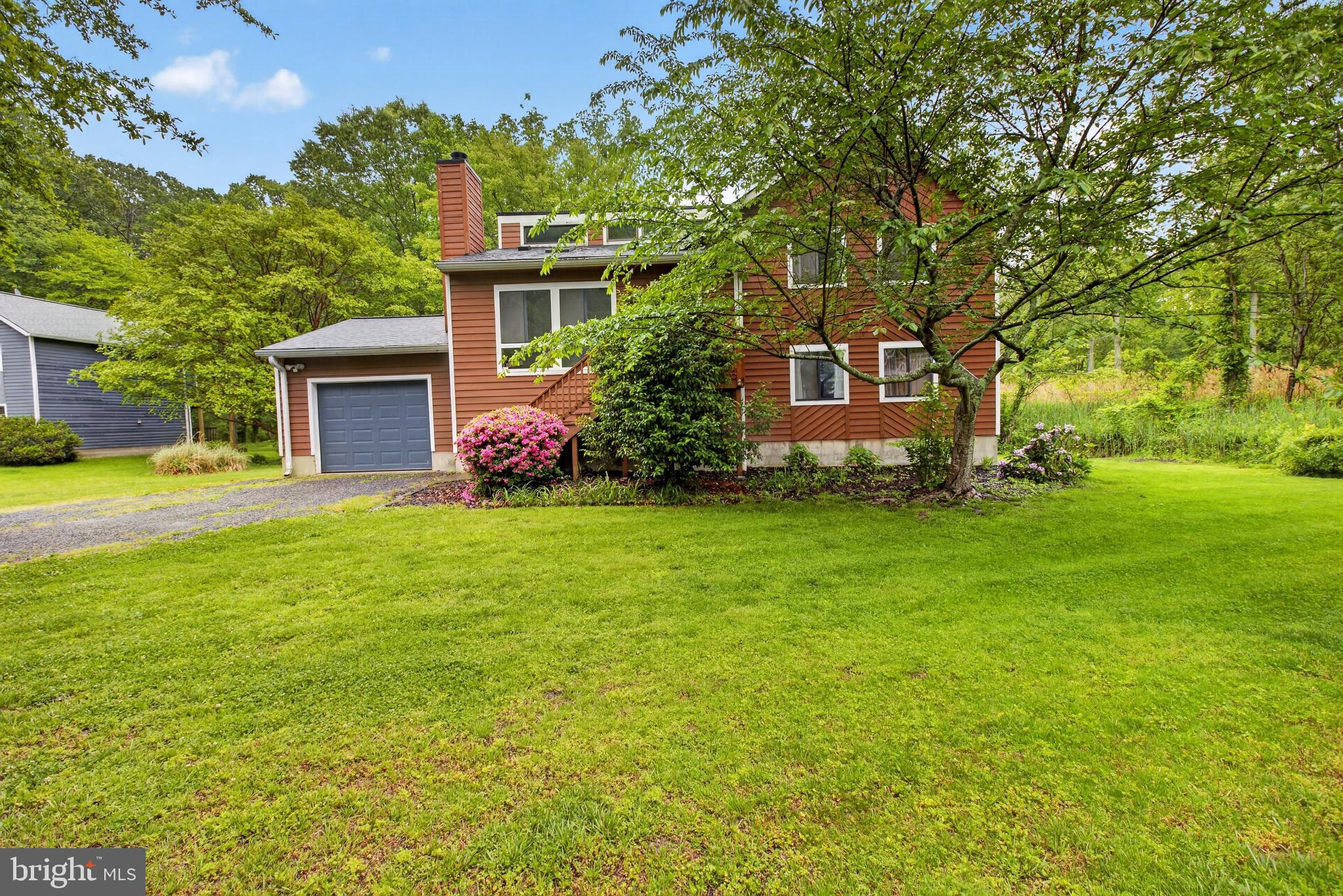 Perched above the Bay with sweeping water views and a private wooded setting! This is the one you've been waiting for! Major system upgrades and seamless indoor-outdoor living make it as functional as it is stunning.
This 4-bedroom, 3-bath home offers a sleek, move-in-ready feel. Inside, hardwood floors run through the main living areas, and cathedral ceilings with large windows bring in natural light while framing the wooded surroundings. The kitchen features white cabinetry, granite counters, stainless steel appliances, and direct access to the deck. It is so easy to cook, gather, and step outside. The living room centers around a modern fireplace and oversized windows that keep the space bright and connected to the outdoors.
The layout includes 4 well-sized bedrooms and 3 full baths, along with a finished basement to add extra room for guests, a rec area, or a home office setup. Multiple outdoor spaces, including an expansive deck and screened-in area, give you room to unwind, host gatherings, or simply take in the view year-round.
The long list of recent updates includes a 3-year-old roof, 1-year HVAC, 2-month-old water heater, and a whole-house water softener and filtration system installed just a year ago. 
Set back on a lush, tree-lined lot, the home captures peaceful views of the Chesapeake Bay and surrounding wetlands, giving you a quiet, nature-filled backdrop that’s hard to find.
Located near Broadwater Creek with easy access to waterfront paths, marinas, and nearby spots like Franklin Manor and local parks, you’re close to outdoor recreation while still having convenient routes to Annapolis and commuter roads.
If you've been searching for a home with real privacy, updated systems, and some of the best water views you'll ever wake up to, this one absolutely needs to be seen in person!