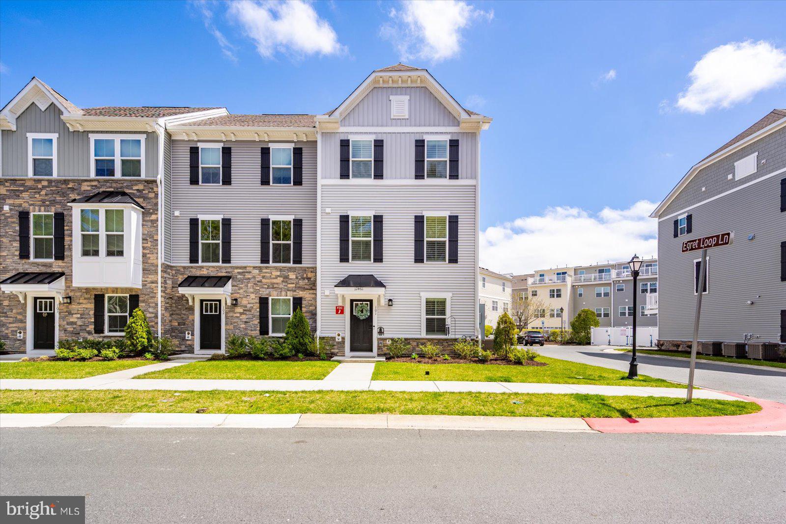Enjoy coastal living in the only end-unit Mozart model townhome with the rare addition of a top floor balcony. Less than 1.5 years old, this spacious home offers the feel of a single-family residence with the ease of low-maintenance townhome living. Inside, you’ll find a bright, open-concept main level with seamless flow between the living, dining, and kitchen areas ideal for everyday living and entertaining. The kitchen features modern finishes, ample cabinetry, and generous counter space, while durable flooring enhances both style and functionality. Multiple levels provide flexible living options, including additional space perfect for guests, a home office, or an additional living area. Key features include a rear-entry two-car garage, multiple outdoor spaces, and a top-floor balcony offering a relaxing spot to unwind. The unique upper level adds privacy and versatility, setting this home apart within the community. Located in the amenity-rich Landings at Bayside community, residents enjoy access to a clubhouse, pools, fitness center, walking trails, kayak launch, and more. Ideally situated just minutes from Ocean City, Berlin, Assateague Island, shopping, dining, and local golf courses, this home offers both convenience and a true coastal lifestyle. Move-in ready and perfectly positioned don’t miss this opportunity to own a standout property near the beach!