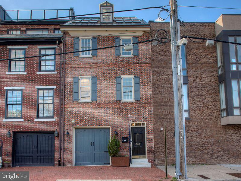 Welcome to 602 S Front located in the Queen Village neighborhood of Philadelphia and home to the blue-ribbon Meredith Elementary school. This turnkey home features 3 bedrooms, 3 1/2 baths, an oversized cook's country kitchen and garage parking. Located on a section of south front with unobstructed Delaware River water views providing for magnificent sunrises, gardens and grassy areas (that you don't have to mow) for kids and the dog and plenty of permit parking.  Within the near future you will have across the street access to Penn's Landing and a short walk to the "new park development" over I-95. This will be a game changer. This bricked front home started out as a trinity and was expanded over the years and was even featured back in 2005 on HGTV as a "good deal" in Philadelphia. The oversized entry features custom wainscotting that flows all the way into the dining room and kitchen, tiled floors, a large coat closet along with inside access to a 1 car garage with extra room for storage. Down the hall is the elevator that services all 4 floors and access to the basement which provides extra use for storage. The rear of the home features an enormous cook's country kitchen with 10' ceilings, wood beams and numerous skylights. This was designed by the current owner as her haven. The tiled floors are radiant heated for extra comfort.  The custom cabinetry in soft beige tones is completed by custom pewter pulls, Volga Blue Tropical granite, stainless steel appliances featuring Subzero, Thermador and Miele. A large island is fitted out with a farmhouse sink and plenty of workspace. Off to the side, there is a coffee station, an area perfect for a home office with storage and built-in desk. A custom China Cabinet with buffet completes the kitchen experience. All the cabinets have lighting that illuminate the interiors and work areas. The large dining room is adjacent. A bar area and powder room complete this level. This could also function as a large open concept living area with seating and dining. It's that big.
Moving along up the center staircase to the 2nd floor where you'll find an east facing living room with custom built- ins, hardwood floors and river views. The first bedroom suite is towards the rear and features a large, carpeted bedroom with an oversized walk-in closet and full ensuite bath with white tile and black stone accents. There is also a full laundry room with a custom unit for folding and a hanging area plus additional storage. The 3rd level features the primary suite with hardwood floors, built-in window benches with storage below and bookshelves, a sumptuous spa-like bath with his/her sinks and oversized shower featuring stone and glass accents. A large walk-in closet completes this space. Another carpeted bedroom with 2 large closets (one a walk-in) and full bath completes this level. The 4th floor features a vaulted ceiling, built-in bar area, sitting area and game room area. The finishing touch is a wall of windows giving you a full water view from the Walt Whitman bridge to the Ben Franklin bridge and a front seat for the fireworks. Off the rear is a spacious deck for relaxing and watching the sunsets.
This home was renovated with the finest finishes including speakers throughout, customized closets in every bedroom, pewter door handles, beautiful light fixtures and energy efficient recessed lighting. No detail was overlooked. A newer gas fired HVAC was recently installed as well.
Perfectly located and within walking distance to the year-round farmer's market at Headhouse Sq and to all of our city landmarks, waterfront activities including the new I-95 Park Cap which is scheduled to break ground in September and some of the best restaurants in the city.  And easy access to I-95 and 676.