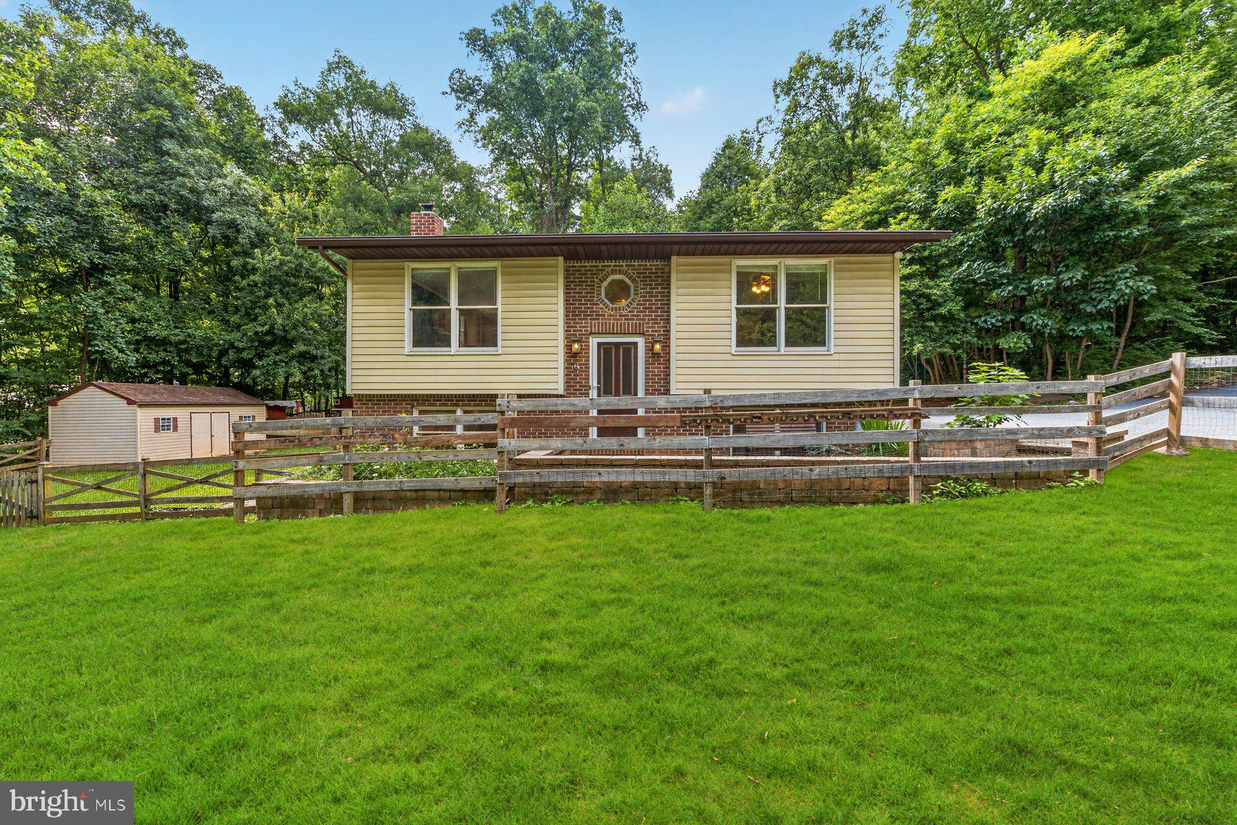 Welcome to your farm-style home! A quaint two bed, two bath house with upstairs and downstairs family rooms that sits on almost 3 acres in a private wooded area. This home is being sold strictly As Is. A lovely farm setting with great bones and a TEMENDOUS VALUE! The basement has a delightful wood stove that will fill the home with warmth on the cold winter days. You will have room to spare with the oversized, two-story garage that features an upstairs office. There are multiple fenced paddocks for small animals, two run in shelters, one animal barn and one storage shed in the backyard. The maple trees in the woods have been marked for tapping syrup in the winter. A raised garden bed awaits fresh vegetable plants in the back. The area around the home has fruit trees, elderberry bushes, and paw-paw trees ready to bring forth fresh fruit. This property has been a pesticide free property for five years! This property is perfect for someone looking for the homesteading lifestyle.