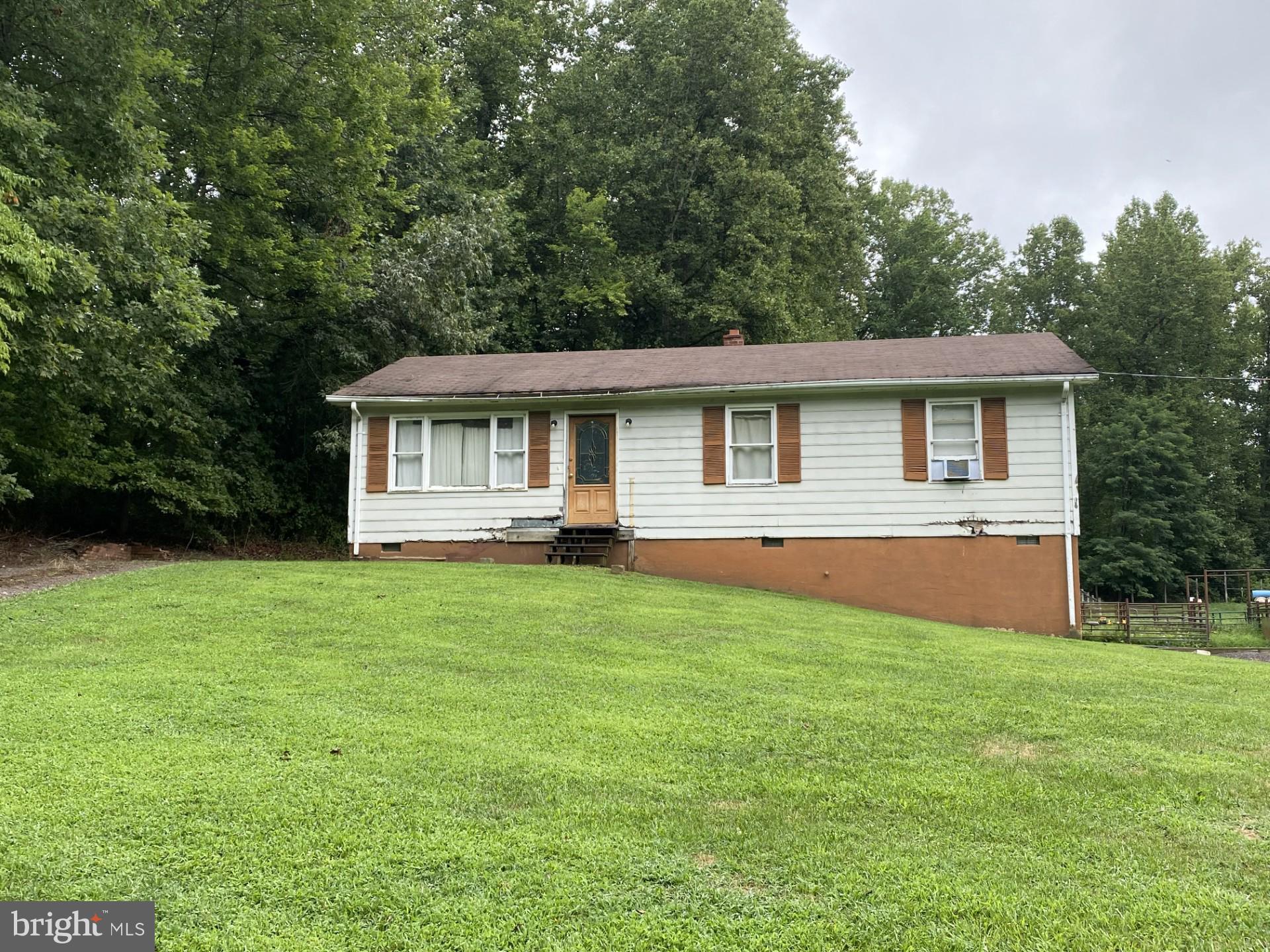 BACK ON THE MARKET  ... BRING YOUR CREATIVITY TO THIS 5.3 ACRE LOT WITH SMALL RANCH STYLE HOME.  THIS IS A PROJECT PROPERTY AND MAY NOT QUALIFY FOR FINANCING AS IT DOES NOT HAVE A HEAT SOURCE OTHER THAN A WOOD STOVE.  THE HOME HAS GOOD BONES AND NEEDS A CREATIVE EYE TO MAKE IT SHINE. SEPTIC SYSTEM NEEDS A NEW DISTRIBUTION BOX AND ONE LINE CLEAREDOR REPLACED.. THE PROPERTY HAS SOME FENCING,  24 X 24 SHOP WITH POWER FOR ALL YOUR STORAGE NEEDS.  DON'T DELAY AND BRING YOUR INVESTORS TODAY.  HOME IS BEING SOLD "AS IS".