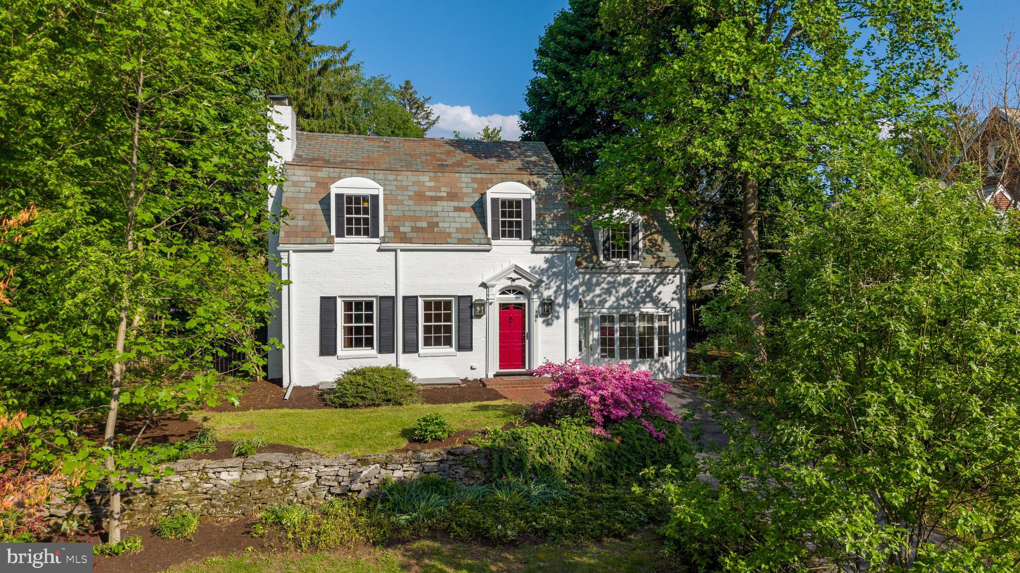 Historic beauty combined with modern openness and natural light awaits on Adams Avenue!  Rich with College Heights charm, this brick home with a slate roof and original historic details showcases enduring character and timeless appeal, while the large back addition features a modern great room for open-concept living lined with walls of windows.  With an exceptional location, this home is < 1/6 mile from Penn State’s campus,  < 1/4 mile from the Arboretum, and only 1.2 miles to Beaver Stadium. The heart of the home is a 2014 open-concept renovation connecting the kitchen and an airy living room, where walls lined with 31 linear feet of panoramic glass dissolve the boundary between the living area and your private, tree-lined backyard sanctuary.  The eat-in kitchen features a custom chef’s island, Corian and granite countertops, and ceramic tile finishes.  The kitchen opens to a beautiful patio, perfect for outdoor entertaining and situated within the private fenced in backyard.  A main-floor guest suite with two private entrances, a bedroom, and full bath adds flexibility for multi-generational living or visitors.  On this level you will also find a dining room, an adjoining family room with a cozy fireplace, and a convenient laundry area, all with gorgeous hardwood floors.  Upstairs, escape to the large primary retreat with soaring vaulted ceilings, private bath, and dual walk-in closets, where a beautiful arched window offers serene treetop views and fills the space with natural light.  Three additional bedrooms with hardwood floors and built-in details are also located on this level, along with an office/den and a full bath featuring a beautifully tiled shower. The lower level adds even more living space with a cozy gathering room centered around an additional fireplace. Solar panels have been added to both the house and garage for modern sustainability and long-term savings.  Generous storage adds functional convenience, including a storage room and two stand-up attics. A detached garage accessible via August Alley completes the property.