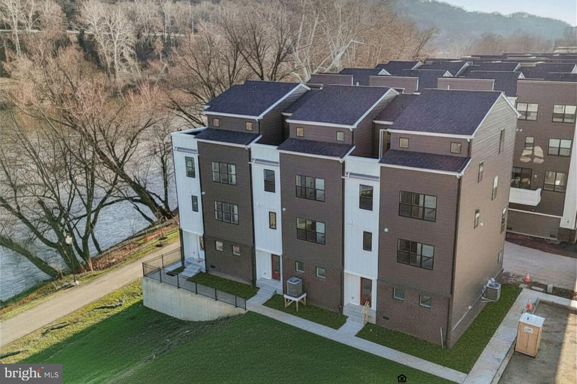 The best was saved for last.  Osprey model, the largest at River Place, with a direct view of the Schuylkill River: four bedrooms and two and a half baths across roughly 2,600 square feet, served on every level by a private elevator. The main level opens to a kitchen finished in quartz with a walk-in pantry and oversized windows that carry light through the living and dining rooms. The primary suite above leads to a private rooftop deck with the river in full view. Built new and delivered move-in ready, the home includes an attached two-car garage plus an additional parking space, upstairs laundry, and an association that maintains the lawn and clears the snow. The Spring Mill train into Center City is a two-minute walk, with the Schuylkill River Trail, Fayette Street, and access to 476 and 76 close at hand. Colonial School District. One of sixty-two homes, and the very last to be offered.