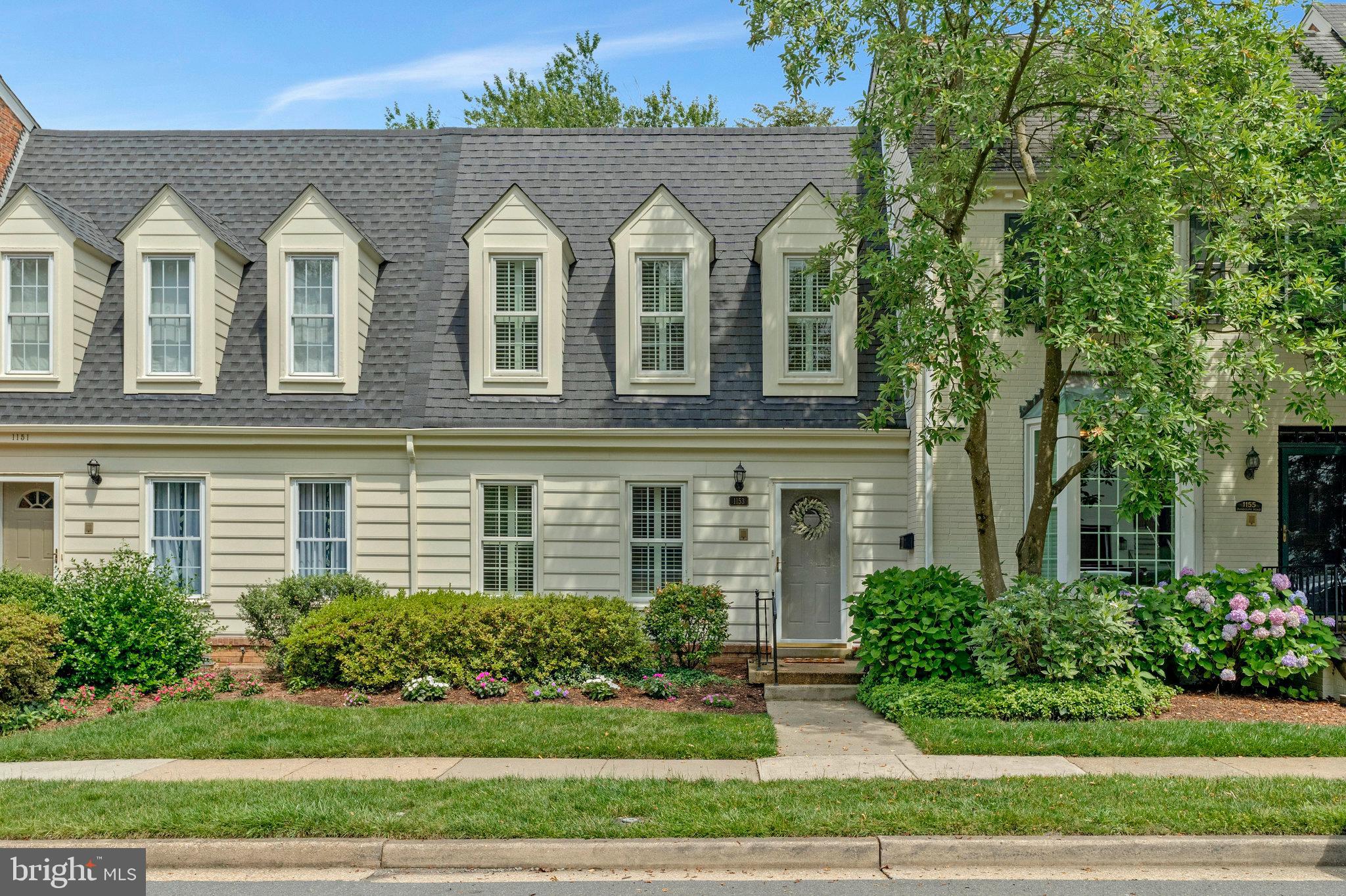 Beautifully maintained townhouse in the sought-after Kings Manor neighborhood of McLean, offering a move-in ready floor plan and fantastic location near downtown McLean, Tysons, D.C., and major commuter routes. Hardwood floors flow throughout the main and upper levels, complemented by recessed lighting and elegant crown molding. The updated kitchen features stainless steel appliances, space for a table, and opens to the dining room—perfect for everyday living and entertaining. The light-filled living room includes a wood-burning fireplace and large window overlooking the patio. 

Upstairs you'll find three spacious bedrooms and two full bathrooms, including a lovely Primary Suite with an updated en-suite bath featuring a walk-in shower and vanity with storage. The finished walk-out lower level adds versatile living space with a recreation room and second wood-burning fireplace, a fourth bedroom, full bath, and a laundry/utility room with storage.

Enjoy the privacy of a fully fenced brick patio with lush landscaping—ideal for relaxing or hosting friends & family. With parking in front and behind the home, plus neighborhood amenities like a playground, picnic area, basketball court, and sidewalks, this is the perfect combination of comfort and convenience in the heart of McLean.