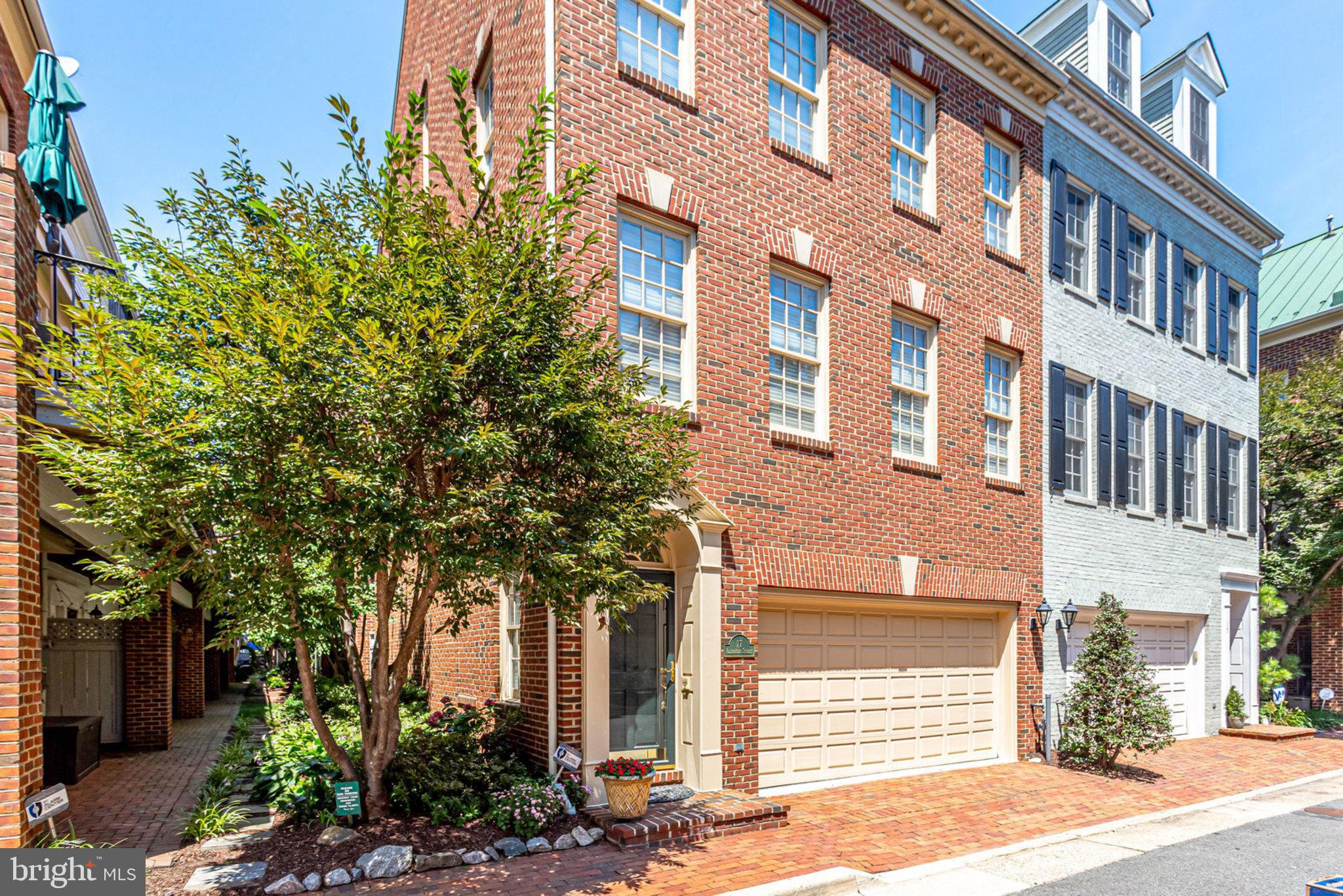 A true Old Town gem—Federal-style end-unit townhome in one of the neighborhood's most coveted pockets, steps from the Potomac, waterfront parks, and King Street.
Fully renovated with nearly 3,000 sq ft of light-filled living, this home features high ceilings and high-end finishes throughout. The open main level is built for entertaining, with hardwood floors, plantation shutters, and a modern tiled feature wall with built-in electric fireplace. The chef's kitchen—white cabinets, quartz counters, glass tile backsplash—opens to a private balcony.
Upstairs, generous bedrooms and spa-inspired baths await, plus flexible space for an office or guest suite. The vaulted primary suite is a bright, tranquil retreat.
The walk-out lower level boasts a mini kitchen and built-in media area with fireplace, opening to a private brick patio and grass courtyard—the only one of its kind in Ford's Landing. A side garden adds even more outdoor space.
Mount Vernon Trail, waterfront dining, boutiques, and Metro—all at your doorstep. Old Town living at its finest.