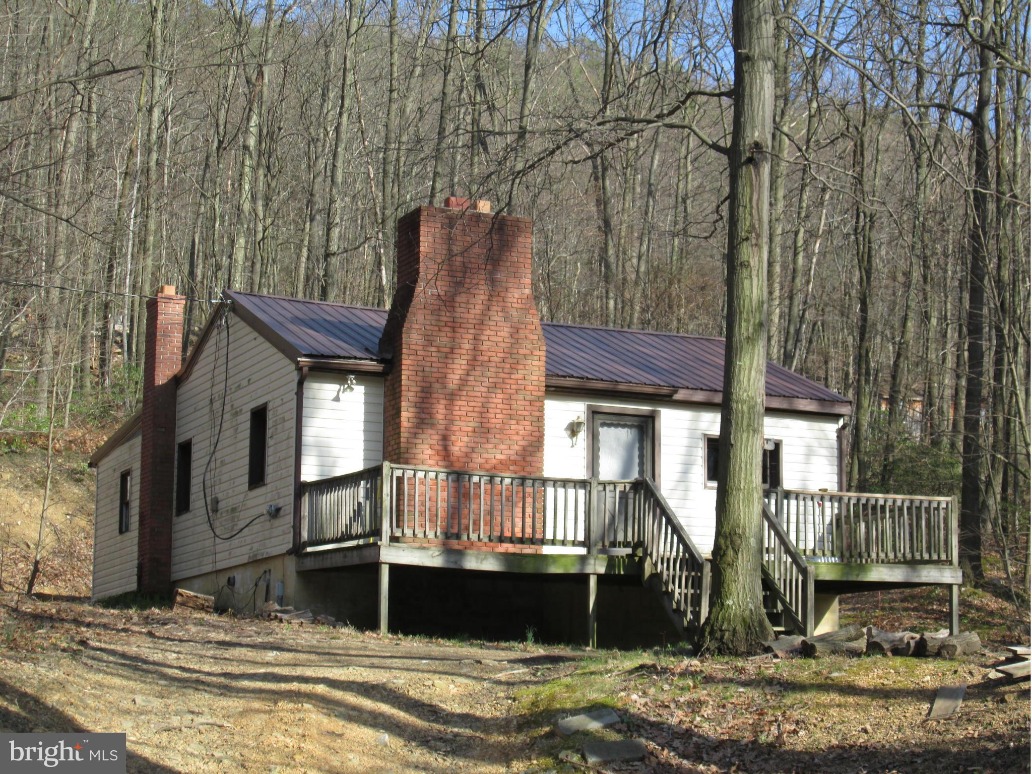 Perfect little getaway! Two bedroom ranch style cabin with a 27X27 detached garage, 1 acre wooded lot, front deck with amazing views and more.. Call for details!