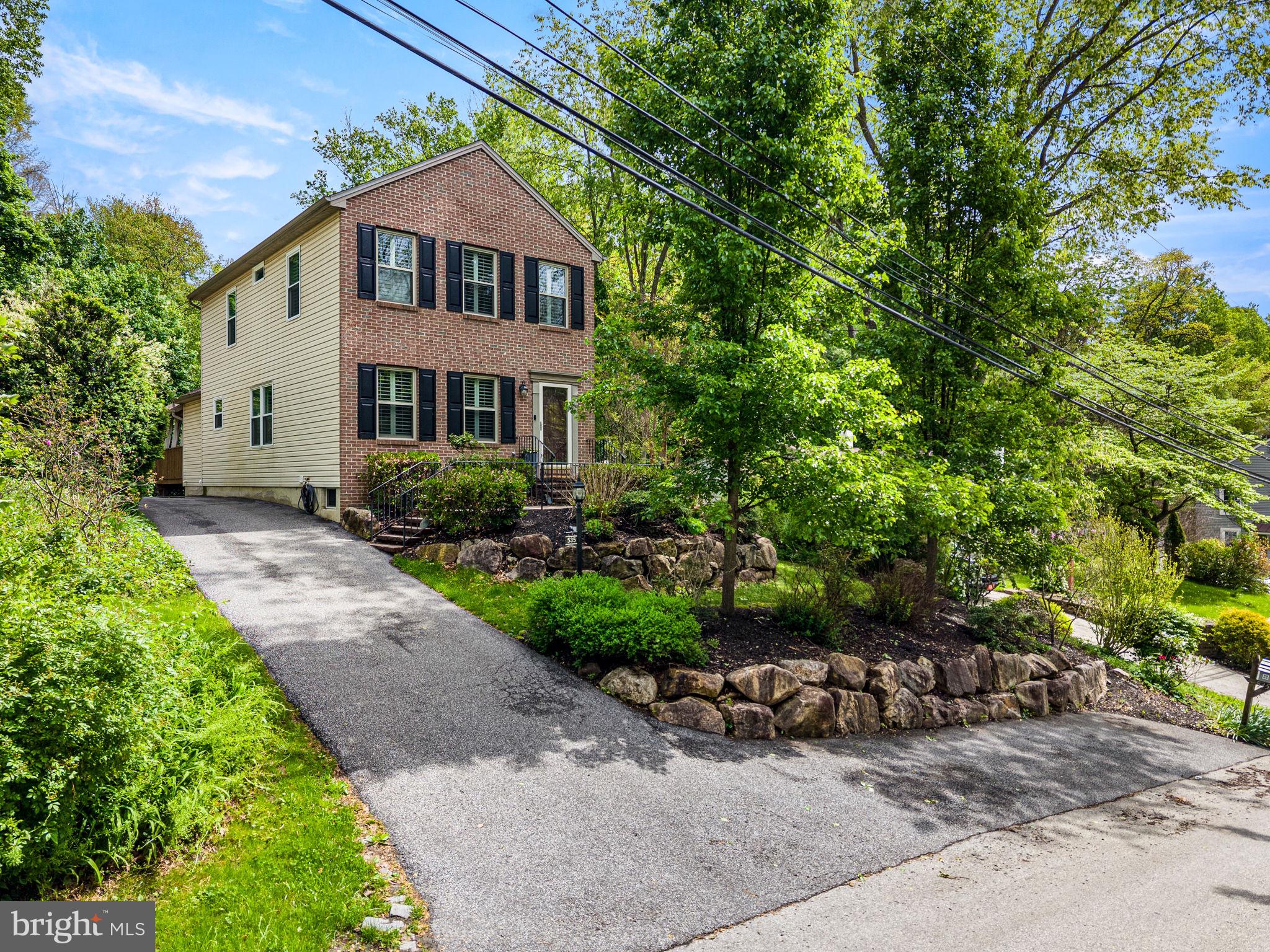Welcome to 535 Ridge Avenue, a beautifully updated brick-front Colonial offering timeless curb appeal, modern finishes, and an exceptional location in the highly sought-after Rose Tree Media School District. From the moment you arrive, the professionally landscaped grounds and inviting exterior create a warm first impression. Inside, the thoughtfully designed open floor plan is filled with natural light and offers the flexibility today's buyers are looking for. The spacious front living area flows seamlessly into the heart of the home, an inviting eat-in kitchen featuring granite countertops, a tiled backsplash, stainless steel appliances, a gas range, recessed lighting, and a built-in pantry. Just beyond the kitchen, a decorative barn door opens to a versatile den or home office with convenient access to the powder room. French doors lead to the covered rear deck, creating the perfect setting for morning coffee, outdoor dining, or entertaining while overlooking the backyard that backs to a peaceful wooded setting. Upstairs, the spacious primary suite provides a private retreat complete with a beautifully appointed en-suite bathroom and generous closet space. Two guest bedrooms and a well-appointed hall bathroom complete the second floor. The lower level offers outstanding flexibility with a custom bar, and ample room plus storage. A separate laundry room with sink and a large utility room provide exceptional functionality. Throughout the home, you'll appreciate numerous updates and designer touches, including hardwood flooring throughout the main level, custom plantation shutters, updated lighting, and tasteful finishes that make this home truly move-in ready. A backyard storage shed provides additional space for outdoor equipment and seasonal storage. Ideally situated just minutes from the shops and restaurants of downtown Media, this home also offers convenient access to Linvilla Orchards, Ridley Creek State Park, Tyler Arboretum, and numerous walking and biking trails. Commuters will appreciate being only three minutes from the Moylan–Rose Valley SEPTA Regional Rail Station and approximately 20 minutes from Philadelphia International Airport. Offering an ideal combination of style, comfort, updates, and an unbeatable location, 535 Ridge Avenue is a home you'll be proud to call your own.