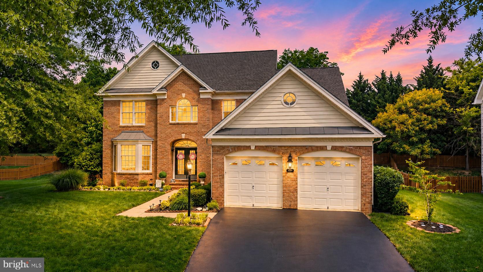 Best Value in DVCC!!! Tucked away on a quiet cul-de-sac in the gated golf course community of Dominion Valley Country Club, this beautifully maintained Arlington model offers over 4,600 square feet of finished living space on a private .24-acre lot backing to mature trees and common area. A dramatic two-story foyer welcomes you inside, where hardwood floors, solid wood stairs with wrought iron balusters, and extensive custom molding set the tone throughout the home. The main level features formal living and dining rooms, a private office, and a spacious family room with a gas fireplace. The updated kitchen is designed for both everyday living and entertaining, featuring granite countertops, newer GE Profile stainless steel appliances, a gas cooktop, and plenty of cabinet and counter space. The open layout flows easily into the family room and out to the backyard. Upstairs, the spacious primary suite includes a sitting area and two walk-in closets with custom closet systems. Three additional bedrooms and well-appointed baths complete the upper level. The finished lower level offers endless possibilities with a large rec room, granite wet bar, full-size refrigerator, full bath, and a generous storage room. Outside, enjoy a maintenance-free deck overlooking the private fenced backyard, plus a stamped concrete patio with a seat wall—perfect for entertaining, relaxing, or enjoying the peaceful wooded backdrop. Recent updates and features include a brand-new roof, new main-level HVAC system, irrigation system, and EV charger. Dominion Valley residents enjoy resort-style amenities including the Arnold Palmer Signature Golf Course, renovated clubhouse, Sports Pavilion, indoor and outdoor pools, tennis and basketball courts, playgrounds, fishing ponds, miles of walking and biking trails, fitness center, and a full calendar of community events. All of this, plus award-winning schools and a convenient location close to shopping, dining, and major commuter routes.