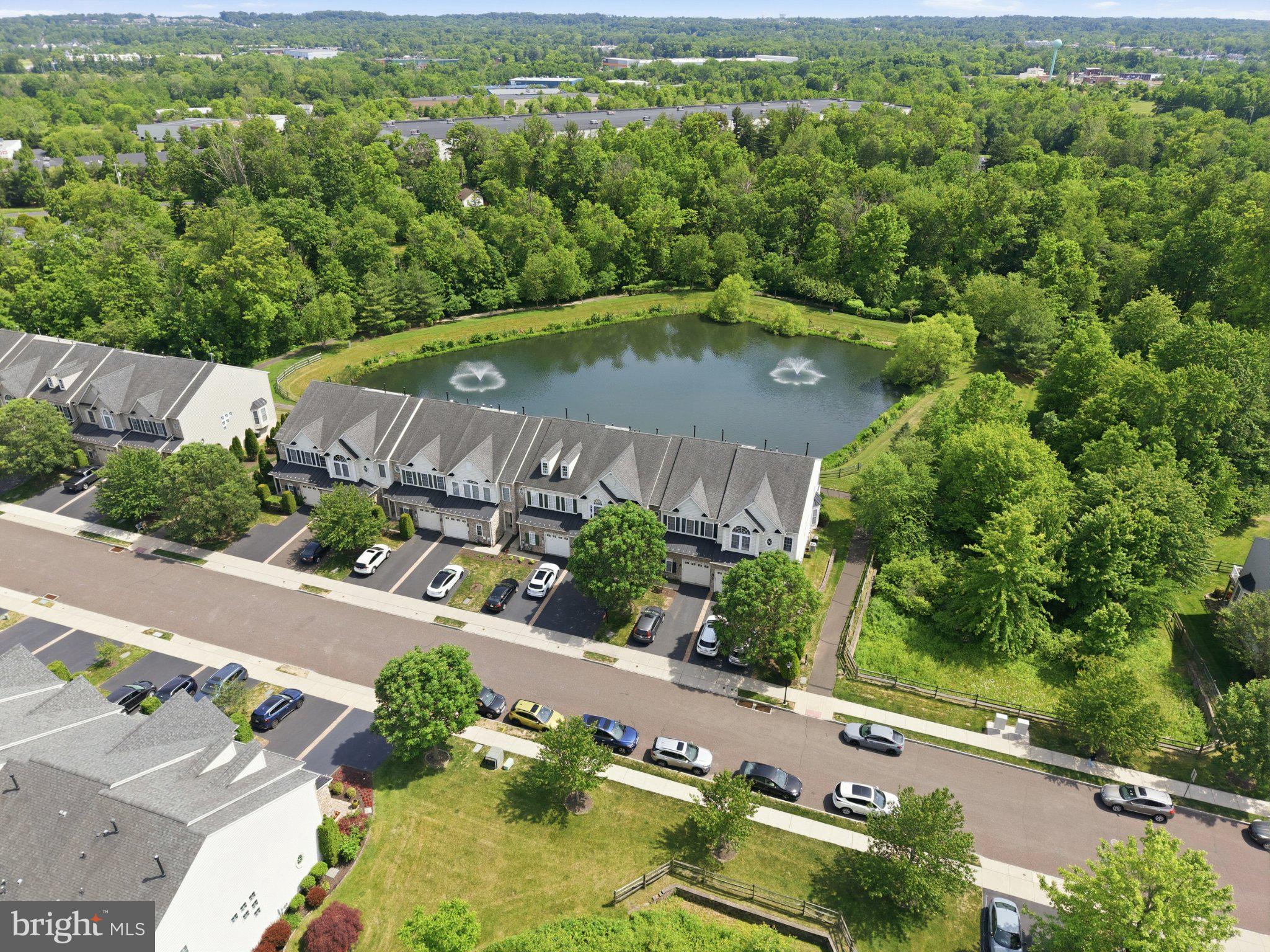 Welcome to a rare opportunity to own a spacious luxury townhome in a premier location within the highly sought-after Reserve at New Britain community, served by the acclaimed Central Bucks School District. Meticulously maintained, freshly painted, and featuring brand-new carpeting throughout the second floor, this exceptional home is perfectly positioned to capture stunning direct pond views, tranquil fountains, and peaceful wooded open space from your own backyard. 

A charming stone-front exterior and covered entry welcome you into the impressive two-story foyer. The open and airy floor plan is enhanced by 9+ foot ceilings on both the main and upper levels, creating a bright and spacious feel throughout. Gleaming hardwood flooring flows throughout the main level, leading to an elegant formal dining room featuring a tray ceiling, chandelier, and chair rail molding. 

The spacious kitchen is designed for both everyday living and entertaining, showcasing stainless steel appliances, a new gas cooktop, double wall ovens, beautiful cabinetry, tile backsplash, pantry, double sink, and an extended raised counter perfect for additional seating.

The adjoining breakfast area opens through French doors to a large maintenance-free deck overlooking one of the community's most desirable settings. Enjoy unobstructed views of the picturesque pond and fountains, peaceful walking trails, and serene wooded surroundings, a truly rare and relaxing backdrop.

The kitchen flows seamlessly into the expansive family room filled with natural light from oversized windows. A convenient powder room completes the main level. 

Upstairs, the spacious primary suite features double-door entry, a tray ceiling, ceiling fan, and an exceptionally large walk-in closet. The luxurious primary bath offers dual vanities, a soaking tub, and a separate shower. Two additional generously sized bedrooms, a full hall bath, and a convenient second-floor laundry room complete the upper level. 

The beautifully finished daylight walk-out basement provides outstanding additional living space with recessed lighting and a full bathroom, making it ideal for a recreation room, home office, guest suite, or fitness area.

Additional highlights include a recently installed HVAC system with efficient two-zone heating and cooling, an extra-wide garage with abundant storage space, and a premium location within the community. 

Ideally situated just minutes from Routes 309 and 202, the SEPTA Lansdale/Doylestown Regional Rail Line, parks, shopping, dining, and the vibrant Doylestown Borough, this home offers the perfect combination of convenience, comfort, and scenic beauty. 

Rarely does a townhome become available with such stunning direct pond views, modern updates, spacious living areas, and an unbeatable location. Move right in and enjoy everything this exceptional home has to offer.