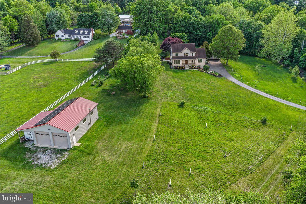 Tucked into the rolling countryside of sought-after Fair Hill, one of Maryland's most coveted natural preserves, this custom-built colonial offers a wonderful balance of comfort, quality, and connection to the outdoors. Set on five gently rolling acres where mornings are quiet and every season writes its own story.

The welcoming front porch introduces interiors filled with warmth and natural light. Rich hardwood and ceramic floors flow throughout the main living spaces, The two-story great room serves as the heart of the home, anchored by a floor to ceiling stone gas fireplace.The open floor plan seamlessly connects the great room to the kitchen, where 42-inch maple cabinetry, Corian countertops, and a sunlit breakfast area create a gathering space that is as functional as it is welcoming. Every room is enhanced by abundant windows that fill the home with natural light and showcase the surrounding landscape.The main-level primary suite provides the convenience of one-floor living and serves as a private retreat featuring two walk-in closets and a spacious ensuite bath with soaking tub, oversized shower, double vanity and private water closet. A private powder bath tucked off the foyer completes the main level.Just off the greatroom finds the updated Trex deck complete with a retractable awning and adjacent hot tub, the outdoor living space is the ideal stage for relaxing during the golden hour after a long day. Travel upstairs to find, two generously sized bedrooms which share a full hall bath and are connected by a hallway overlook that captures views of the great room below.The unfinished lower level offers endless possibilities for future expansion, with plumbing already in place for a full bath. The laundry/ utility room and 2 car attached garage completes this level Thoughtfully maintained, the home also features a new 2025 HVAC system with heat pump and propane backup, central vacuum,EV charging outlet and 2022 owned solar panels that have historically offset nearly all of the property's electrical needs. ( 30 panel 12.0 kWdc system)  The outbuildings are equally impressive: First, a two-car detached garage, and then the best part is the 50' x 30' pole barn equipped with water, electric, wood stove, and an attached 30' x 12' lean-to perfect for camper, boat, or equipment storage. She shed, man cave, or barn for the livestock ? ? ..... We will let you fight that one out ;)

Just around the corner is Fairhill NRMA with 9,000 acres of preserved open space offering miles of hiking, biking, and equestrian trails, along with year-round equestrian competitions, outdoor recreation, and community events. A home where nature, recreation, and everyday living come together effortlessly, this is a truly special property—one that is well worth your time and attention.