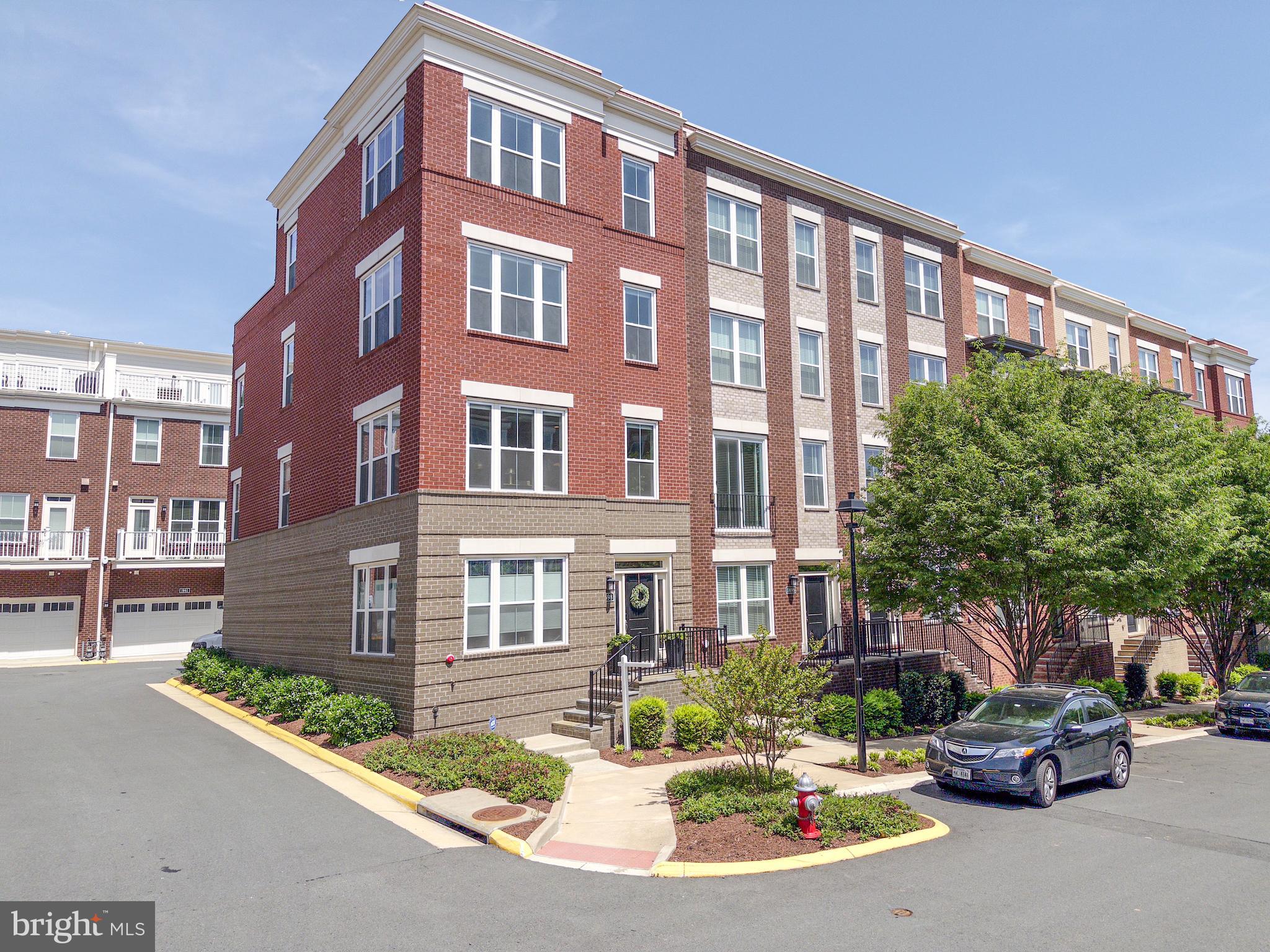 Found it!  Discover the Mayor’s Residence—a standout.  Largest available, elevator-ready, rare 5-BR 4.5 BA 2 Car Garage in sought-after Sunrise Square.  End Unit.  Urban living w/great rooftop terrace w/views of both sunrises and sunsets.  2018 new build.  1st floor bedroom & private 4th floor guest suite.  Hardwood throughout, massive ceilings.  “Delight in natural light!” 6 ft windows w/custom blinds everywhere.  9 1/2 x 6 ft Quartz kitchen island w/Thermador & Bosch Appliances.  Bistro deck patio off kitchen/dining area.  Spa day every day in the handsome master bath.  Custom closets in primary bedrooms.  Upscale customized trim package.  Recessed lights on every floor. Check out the golden door knobs!  The rooftop…New composite deck tile!  Cookout, unwind, entertain, or take after the current owner and host neighborhood yoga sessions!  New Epoxy in Garage!  New washer & dryer, custom paint &lighting.  Dog-friendly community with its own dog park. .  Walk to Metro, Wegmans, trails, and more. Minutes to the toll road, RTC, and top shopping.