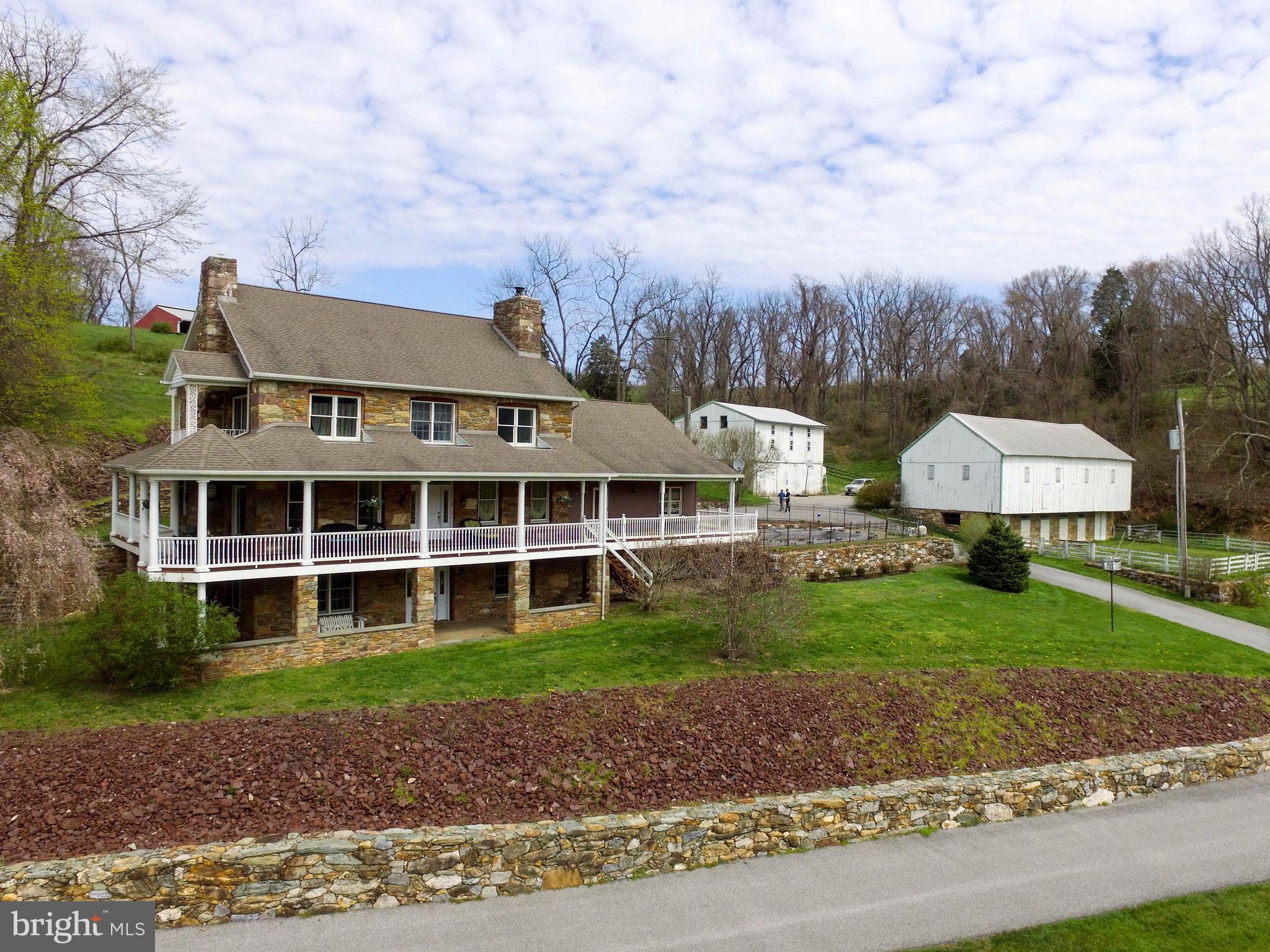 This Home has Charm! 200 year old stone & log home without needing all the updating! Stone & cedar exterior, exposed beams, wrap-around porch with panoramic views, southern exposure, 6 fireplaces, wood floors, custom kitchen with granite island, counters & back splash, in-ground pool, private pond, fenced pastures & so much more! Would make a great Bed & Breakfast. Perfect home for the equine lover/trainer/boarder. Property in Clean & Green program. Prime location, only minutes to I83.