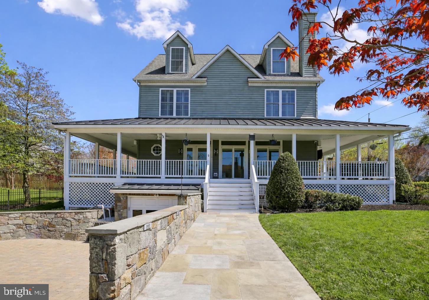 Welcome to 4557 Fairfield Drive, blending timeless charm and thoughtful updates with exceptional curb appeal. The classic façade is complemented by a wraparound front porch, creating a warm and inviting presence while providing the perfect setting for outdoor lounging, dining, or simply enjoying the neighborhood streetscape. Elevated above the street and approached by a stone walkway, the property is framed by a manicured lawn, mature trees, and seasonal plantings. From every angle, the property reflects a seamless blend of classic design, modern livability, and inviting outdoor spaces. At the heart of the home, a stunning Poggenpohl kitchen sets a tone of understated luxury and precision design. Clean-lined European cabinetry in warm wood tones is paired with sleek matte finishes, creating a refined yet welcoming aesthetic. Expansive waterfall-edge quartz islands provide striking visual impact while offering generous space for cooking, gathering, and entertaining. Outfitted with integrated, top-tier Miele appliances—including a built-in coffee system, wall ovens, and a professional-grade gas cooktop—the kitchen is thoughtfully designed for both form and function. Custom storage solutions are seamlessly incorporated throughout, maintaining the minimalist elegance Poggenpohl is known for. The space flows effortlessly into adjacent living and dining areas, making it equally suited for everyday living and sophisticated entertaining. Upstairs, the bedroom level offers a well-balanced and functional layout. The primary suite features two closets—including a walk-in—and a private en suite bath, creating a comfortable retreat. This level also includes a second bedroom and full hall bath, as well as a smaller third bedroom ideal for a home office, nursery, or flex space. Laundry is conveniently located on this floor. The top floor expands the home’s versatility with two additional bedrooms and a full bath. The fully finished lower level is anchored by a sleek Poggenpohl-designed secondary kitchen and bar area. A large central island with seating serves as a natural gathering point, complemented by integrated appliances and a wine refrigerator—ideal for entertaining. Custom built-ins provide concealed storage while maintaining clean, modern lines, and the open layout transitions seamlessly into a media lounge, enhanced by a textured feature wall, warm wood cabinetry, and durable tile flooring. Originally built in 2005, this home has been extensively updated and meticulously maintained, reflecting true pride of ownership. Major improvements include a redesigned paver driveway, along with an attractive fence anchored by stone pillars. Interior renovations have thoughtfully modernized the home, including updates to both powder rooms, a renovated third-floor bathroom, and a significant main-level remodel featuring new flooring and updated porch windows and doors. Mechanical systems have also been carefully maintained, with HVAC systems replaced (2018), water heaters updated (2020), and a new sump pump installed (2026). This A+ location provides easy access to Metro (NIH or Bethesda), along with the vibrant dining, shopping, and cultural amenities of downtown Bethesda. Just minutes from NIH, Walter Reed National Military Medical Center, and Rock Creek Park, this highly walkable location perfectly balances neighborhood tranquility with urban convenience.
