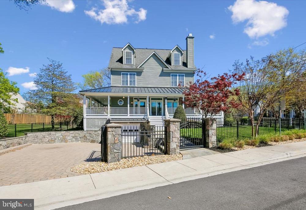 Welcome to 4557 Fairfield Drive, blending timeless charm and thoughtful updates with exceptional curb appeal. The classic façade is complemented by a wraparound front porch, creating a warm and inviting presence while providing the perfect setting for outdoor lounging, dining, or simply enjoying the neighborhood streetscape. Elevated above the street and approached by a stone walkway, the property is framed by a manicured lawn, mature trees, and seasonal plantings. From every angle, the property reflects a seamless blend of classic design, modern livability, and inviting outdoor spaces. At the heart of the home, a stunning Poggenpohl kitchen sets a tone of understated luxury and precision design. Clean-lined European cabinetry in warm wood tones is paired with sleek matte finishes, creating a refined yet welcoming aesthetic. Expansive waterfall-edge quartz islands provide striking visual impact while offering generous space for cooking, gathering, and entertaining. Outfitted with integrated, top-tier Miele appliances—including a built-in coffee system, wall ovens, and a professional-grade gas cooktop—the kitchen is thoughtfully designed for both form and function. Custom storage solutions are seamlessly incorporated throughout, maintaining the minimalist elegance Poggenpohl is known for. The space flows effortlessly into adjacent living and dining areas, making it equally suited for everyday living and sophisticated entertaining. Upstairs, the bedroom level offers a well-balanced and functional layout. The primary suite features two closets—including a walk-in—and a private en suite bath, creating a comfortable retreat. This level also includes a second bedroom and full hall bath, as well as a smaller third bedroom ideal for a home office, nursery, or flex space. Laundry is conveniently located on this floor. The top floor expands the home’s versatility with two additional bedrooms and a full bath. The fully finished lower level is anchored by a sleek Poggenpohl-designed secondary kitchen and bar area. A large central island with seating serves as a natural gathering point, complemented by integrated appliances and a wine refrigerator—ideal for entertaining. Custom built-ins provide concealed storage while maintaining clean, modern lines, and the open layout transitions seamlessly into a media lounge, enhanced by a textured feature wall, warm wood cabinetry, and durable tile flooring. Originally built in 2005, this home has been extensively updated and meticulously maintained, reflecting true pride of ownership. Major improvements include a redesigned paver driveway, along with an attractive fence anchored by stone pillars. Interior renovations have thoughtfully modernized the home, including updates to both powder rooms, a renovated third-floor bathroom, and a significant main-level remodel featuring new flooring and updated porch windows and doors. Mechanical systems have also been carefully maintained, with HVAC systems replaced (2018), water heaters updated (2020), and a new sump pump installed (2026). This A+ location provides easy access to Metro (NIH or Bethesda), along with the vibrant dining, shopping, and cultural amenities of downtown Bethesda. Just minutes from NIH, Walter Reed National Military Medical Center, and Rock Creek Park, this highly walkable location perfectly balances neighborhood tranquility with urban convenience.