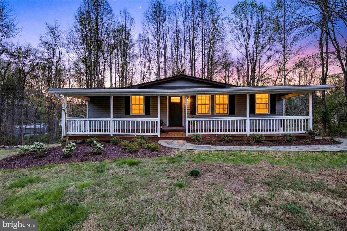 Completely remodeled and thoughtfully reimagined, this two-bedroom, two-bath home offers a warm, inviting interior paired with a layout designed for everyday comfort and effortless entertaining. The main living space features rich flooring, exposed beam ceilings, and a beautifully updated fireplace that creates a natural focal point and adds character throughout.

The kitchen has been upgraded with modern cabinetry, sleek countertops, and a clean, functional design that flows seamlessly into the dining area. Large windows and sliding glass doors bring in natural light and connect the interior to the spacious rear deck, creating an easy indoor-outdoor living experience.

Both bedrooms offer a comfortable, well-appointed feel, designed to provide a sense of retreat and simplicity.

A covered front porch with wood detailing sets the tone from the moment you arrive, offering a welcoming space to relax and unwind. The large rear deck overlooks a natural, wooded setting, providing privacy and a peaceful backdrop.

The unfinished basement presents a valuable opportunity for future expansion, allowing the next owner to create additional living space, a recreation area, or storage tailored to their needs.

The property also includes an assigned deep-water boat slip, making lake access convenient and enjoyable. Located just minutes from Lake Anna’s popular waterfront dining, shopping, and local attractions, and equipped with high-speed internet, this home offers a balanced combination of comfort, character, and potential.