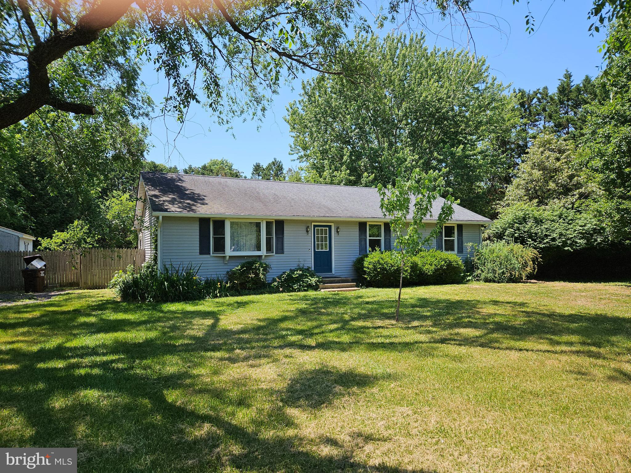 This charming ranch-style home, built in 1986, offers a perfect blend of comfort and functionality. Minutes to Tuckahoe Creek boat ramp! With 1,300 sq. ft. of well-designed space, it features three inviting bedrooms and two full bathrooms, including a primary suite with a walk-in closet and a tub/shower. The traditional floor plan is enhanced by built-ins and ceiling fans, creating a cozy atmosphere throughout. The kitchen is equipped with modern appliances, including a built-in microwave, dishwasher, and  newer electric range, making meal prep a delight. There is a dining area just off the kitchen, with backyard and deck access, along with a breakfast bar. Enjoy gatherings and privacy in the fully fenced backyard, taking advantage of the brand new deck.  There is also a apple tree and there may still be some blackberry, raspberry and blueberry bushes. The shed in the backyard, with electric, is an added plus. Additional highlights include durable flooring options such as hardwood, laminate and ceramic tile. Enjoy the convenience of town amenities, just about 10 minutes away (Easton or Denton). Located on a peaceful  street, this home is a serene retreat, ready for you to create lasting memories. Don't miss the opportunity to make this inviting space your own!