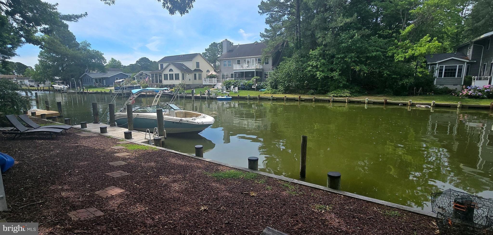 Amazing Waterfront 3-Bedroom, 2-Bath Cottage in Ocean Pines Resort!  Experience waterfront living at its finest in this charming 3-bedroom, 2-bath cottage featuring an expansive bulkhead with room for both your boat and Jet Skis.  Whether you're heading out for a day on the water or enjoying the peaceful views from home, this property offers the perfect coastal lifestyle.  The oversized rear deck and spacious backyard create an ideal setting for entertaining family and friends or simply relaxing while taking in the beautiful waterfront scenery.  Inside, you'll find an updated custom kitchen complete with granite countertops, stainless steel appliances, and abundant custom cabinetry.  Beautiful hardwood floors flow throughout the main level, leading to a spacious living room with a cozy wood-burning fireplace, built-in wood storage, and remarkable water views.  The large dining area provides plenty of space for gatherings and is conveniently located adjacent to the kitchen.  Step directly from the living room onto the expansive rear deck, where you can dine outdoors, entertain guests, or unwind while enjoying the tranquil waterfront setting.  The main level also features a full bathroom, providing added convenience for family and guests.  Upstairs features three well-appointed bedrooms, with the primary bedroom showcasing beautiful water views that provide a relaxing backdrop to start and end your day.   Additional features include an attached garage and ample parking with a five-car driveway.   Ideally located with easy access to the Saint Martin River and Isle of Wight Bay, this home is nestled within the sought-after Ocean Pines Resort community, offering the perfect combination of waterfront living, boating, fishing, and resort-style amenities.  Don't miss this opportunity to own a beautiful waterfront retreat with direct water access and exceptional outdoor living. Schedule your private showing today!