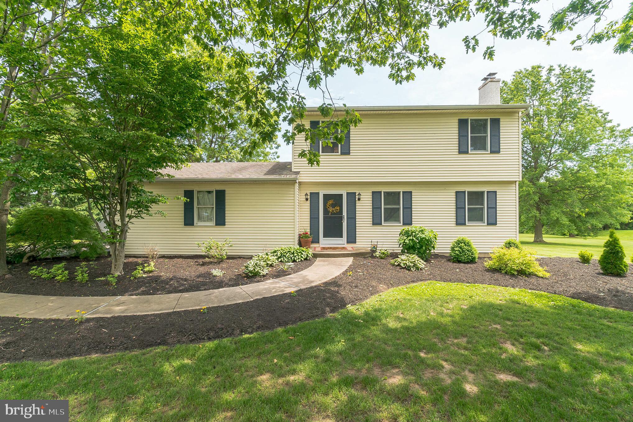 With breath-taking views of Bucks County countryside from every window of this home, this beautiful colonial is tucked in an idyllic setting of shade trees and nature.   The warmth of the free-standing woodstove with attractive brick detail guarantees that the living room will be the ultimate gathering spot; this room boasts hardwood floors, chair rail and crown molding.  The dining room is filled with natural light from a delightful bay window which provides an unobstructed view of the backyard full of birds and wildlife. Bright with white cabinetry and appliances, the kitchen offers a breakfast bar, double oven, ceiling fan, built-in microwave, dishwasher and double sink. The spacious laundry room has an exit door opening to an exceptional 24' X 15'  concrete patio. Since trees and shrubs border the enviable backyard, this is a tranquil retreat for watching the sunrise with your morning coffee.  Three generously-sized bedrooms with hardwood flooring and a ceiling fan in each plus a roomy full bath complete the 2nd floor.  An attractively-placed 19'  X 13'   outbuilding  with electric and double entry doors provides ample room for lawn maintenance and recreational equipment.    You can park 10 or more cars on the remarkable long driveway with turnaround, so large backyard barbeques are easy to host!   Looking out the front door, there is an open field across the street and behind this lot is another field - it just doesn't get more picture-perfect than that. Special features include welcoming curved front walkway, six-panel doors and easy-to-maintain flooring throughout the home, main-floor powder room, two-car side-entry garage with built-in cabinets and some recently-replaced windows. It's only an eight minute ride to the Chalfont Train Station and only twelve minutes to enjoy all the charming shopping and delicious restaurants for which Doylestown is known.  Within walking distance of Tabora Farms and just a quick ride to Peace Valley Park, this property is located in the highly-regarded Central Bucks School District.   This homesite is very special and needs to be seen to be appreciated.