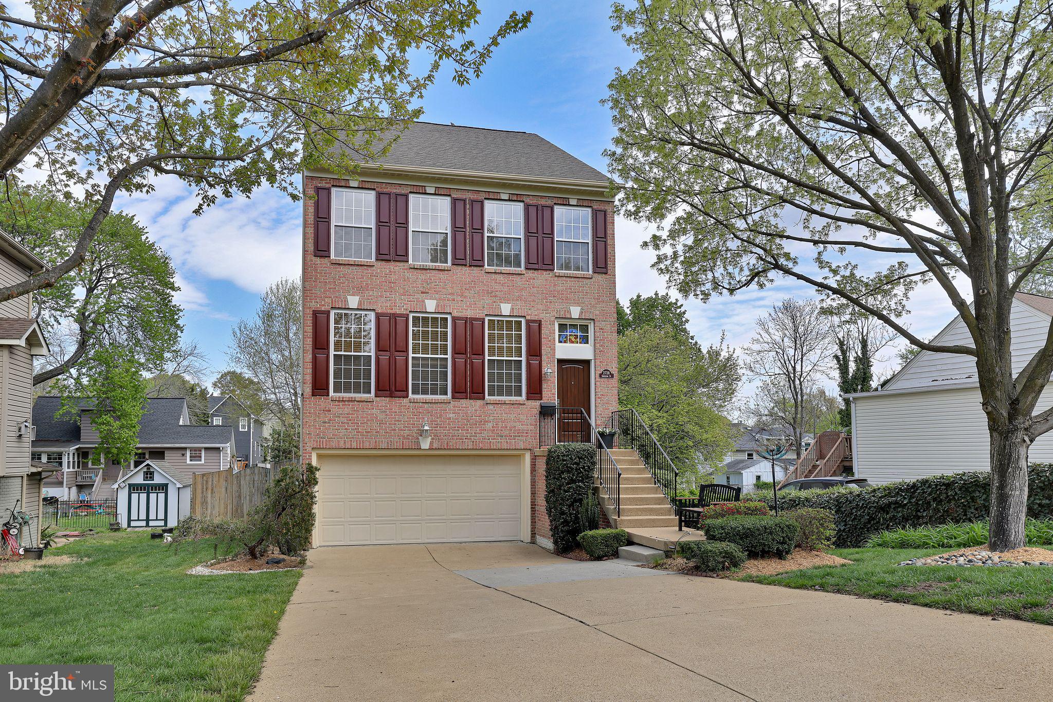 GORGEOUS ON GROVETON – Impeccably maintained in Alexandria's Memorial Heights neighborhood, 2728 Groveton St. is the wonderfully welcoming home you've been waiting for. From the brick facade to the lusciously landscaped backyard, you will be immediately impressed. The care and thoughtfulness that have gone into this home make it a true showplace. Entering through the sunken foyer with attractive accent wall, the rich wood floors of the main level invite you inside. Natural light pours across the living room, formal dining room, and gourmet kitchen with pass-through. Sliders opening to the handsome red deck tempt you outside, but not just yet…. First, move upstairs along the staircase featuring a dramatic designer light fixture. This top floor features a soaring cathedral ceiling, two bedrooms and full bath to the front of the house, and primary suite facing the bucolic back. This suite nods to the practical with an expansive walk-in closet and custom ceiling fan, as well as to the luxurious with a spa-like bath featuring a soaking tub wrapped in windows, double vanity, and walk-in shower. The lower level also emphasizes the practical, with laundry room, pristine double-car garage, and another full bath. It's also the coziest carpeted spot in the house, perfect for lounging. Here, however, the second set of sliders succeed in pulling us outdoors and into a lush wonderland. Stepping onto the multi-tiered deck, which starts above at the kitchen, appreciate that it cascades deeper still into this oasis of serenity. While attractive nearly any time of year, this space comes pre-wired for a hot tub, should you wish to enjoy this fenced retreat on even the coldest winter days. Convenience, too, is year-round, with all the access and amenities of Richmond Highway barely two blocks beyond this rolling residential address. With all this and more, 2728 Groveton St. is truly in a league of its own.