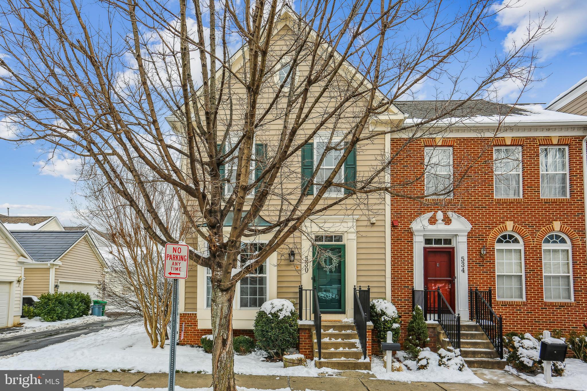 Spacious, beautifully updated, light-filled end unit in exceptional location. Possibly the most popular townhome model in Lakelands, this four-level Tarquin has updates and special features in every room. Updated  hardwoods lead from the main-level entry foyer into the large living room and adjoining dining room. The generous kitchen has been updated to include corian countertops and stainless steel appliances and adjoins a versatile dining area with a roomy double-door pantry. The kitchen opens to the large family room which features a gas-burning fireplace and access to the expanded deck. This level also features an updated powder room and convenient coat closet. Upstairs, the luxury primary suite has a double-door entry and includes a spacious walk-in closet, a large double-door closet, and a spa-like en-suite bath with upgraded tilework and a glass-enclosed shower plus a decorator double-vanity with custom cabinetry, lighting, and fixtures. The second and third bedrooms are large and bright and the second full bath has been beautifully updated. The laundry room has also been relocated to this level offer the ultimate in convenience. The large fourth level offers a versatile space perfect for its current use as a big fourth bedroom and is also perfect for a home office, playroom, studio, lounge, exercise area, or any creative use. Highlights of the lower level include LVT flooring, an expansive recreation room, two big bonus rooms, a large storage room, and a third full bath. The two-car garage is easily accessible from the sunny deck. Together with a fabulous location a quick stroll from the countless shopping, dining, recreation, and entertainment options this sought-after and award-winning community has to offer, this home has it all!
