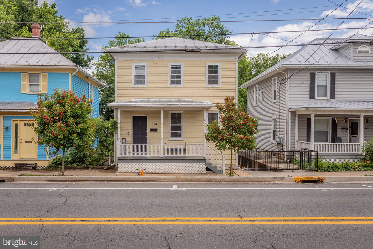 Welcome to 234 N. Main Street in the heart of Woodstock, where small-town charm, everyday convenience, and classic character all come together. Perfectly located near local shops, restaurants, and downtown favorites, this inviting home gives you a front-row seat to Woodstock’s beloved town parades right from your own front porch.
Inside, you’ll find a spacious living room filled with charm and warmth, offering a comfortable place to gather, relax, or unwind at the end of the day. The main level also features a full bathroom with laundry, plus a flexible nook that could make a great play space, reading corner, or home office.
The updated eat-in kitchen is full of personality and is sure to be a favorite spot in the home. A large butcher block island offers plenty of prep and gathering space, while the dining area provides room for a generous table. The beautiful fireplace serves as the centerpiece of the kitchen, adding character and charm you don’t often find.
Upstairs, you’ll find two nicely sized bedrooms and an incredibly charming bathroom with a classic clawfoot bathtub. Out back, enjoy a covered rear porch, newly built outbuilding, and rear parking with room for multiple vehicles, an incredible bonus for a downtown Main Street location.
With its inviting layout, charming details, and walkable Woodstock setting, 234 N. Main Street is ready to welcome you home.