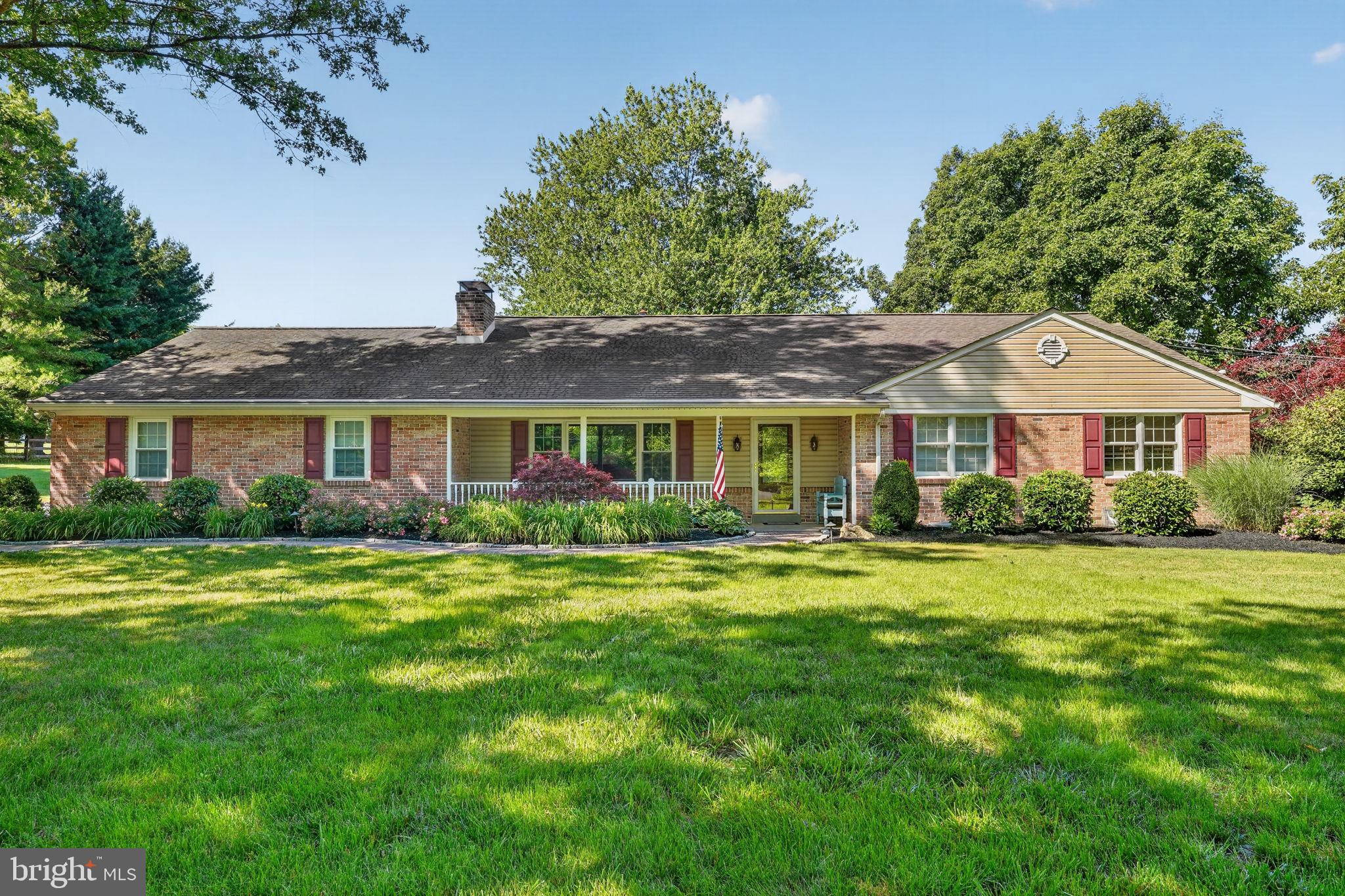 Welcome to this exceptional ranch home nestled on 1.5 beautifully landscaped acres in the highly desirable North Penn School District, offering the perfect blend of comfort, functionality, and versatility. The main residence features 3 bedrooms, 2 full baths, and 2 half baths, along with a rare Township-approved one-bedroom, one-bath apartment/in-law suite complete with its own full kitchen, laundry room, generous storage, and private composite deck-ideal for multigenerational living, guests, or rental potential. A charming brick paver walkway leads to the inviting front porch and into a warm, welcoming interior highlighted by hardwood flooring throughout the living and dining rooms. The spacious living room features a beautiful brick wood-burning fireplace, custom built-in cabinetry, and a large bay window that fills the space with natural light. The dining room flows seamlessly into the well-appointed kitchen, where you’ll find an abundance of cabinetry, Corian countertops, stainless steel appliances, and a center island topped with granite. Just beyond, the expansive four-season sunroom overlooking the private backyard is the perfect place to relax year-round, offering a striking brick accent wall, recessed lighting, and a freestanding propane fireplace. A convenient powder room and first-floor laundry/mudroom with garage access add to the home’s thoughtful layout. The primary suite offers dual closets and shares a beautifully updated Jack-and-Jill bathroom with the hallway, featuring dual vanities, a radiant heated tile floor, and a tiled shower. The second bedroom includes its own private half bath, while the third bedroom provides additional space for family or guests. The finished lower level expands your living space with a second brick wood-burning fireplace, wet bar, full bathroom, recessed lighting, and the durable Owens Corning wall system, plus additional unfinished storage space. Step outside to your own private retreat featuring an extensive brick patio, mature landscaping, custom flagstone hardscaping, a stunning outdoor brick fireplace, and landscape lighting-creating the perfect setting for entertaining or enjoying peaceful evenings at home. An exterior rear staircase provides access to the private apartment/in-law suite, while the spacious yard also includes a large storage shed and plenty of room to enjoy the surrounding 1.5-acre property. Conveniently located just minutes from the PA Turnpike, shopping, dining, and everyday amenities. This truly one-of-a-kind property offers endless possibilities for multigenerational living, rental income, or simply enjoying the flexibility of a home designed to adapt to your lifestyle.